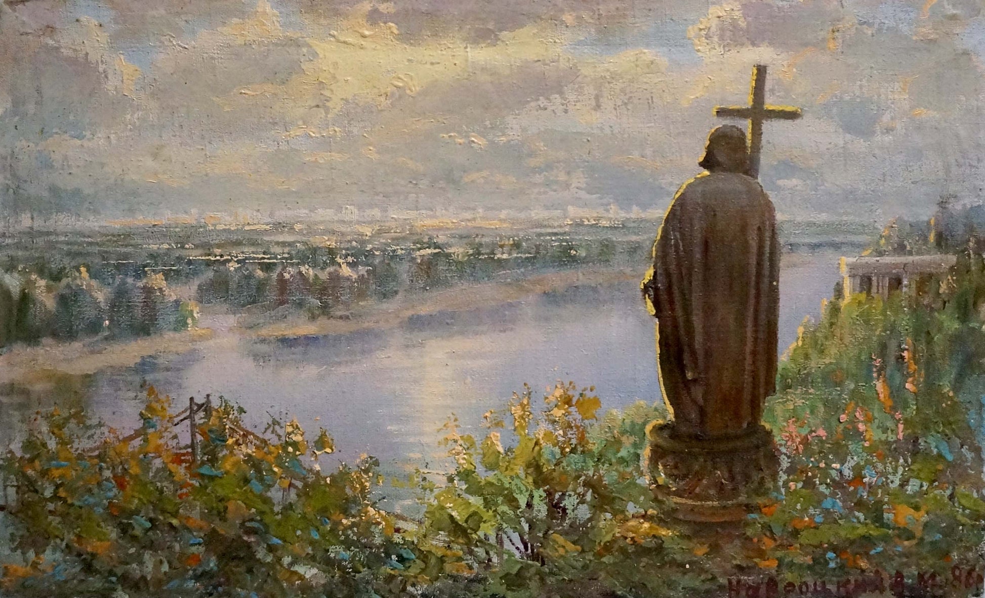 Bronze Saint Vladimir statue with cross on pedestal in greenery