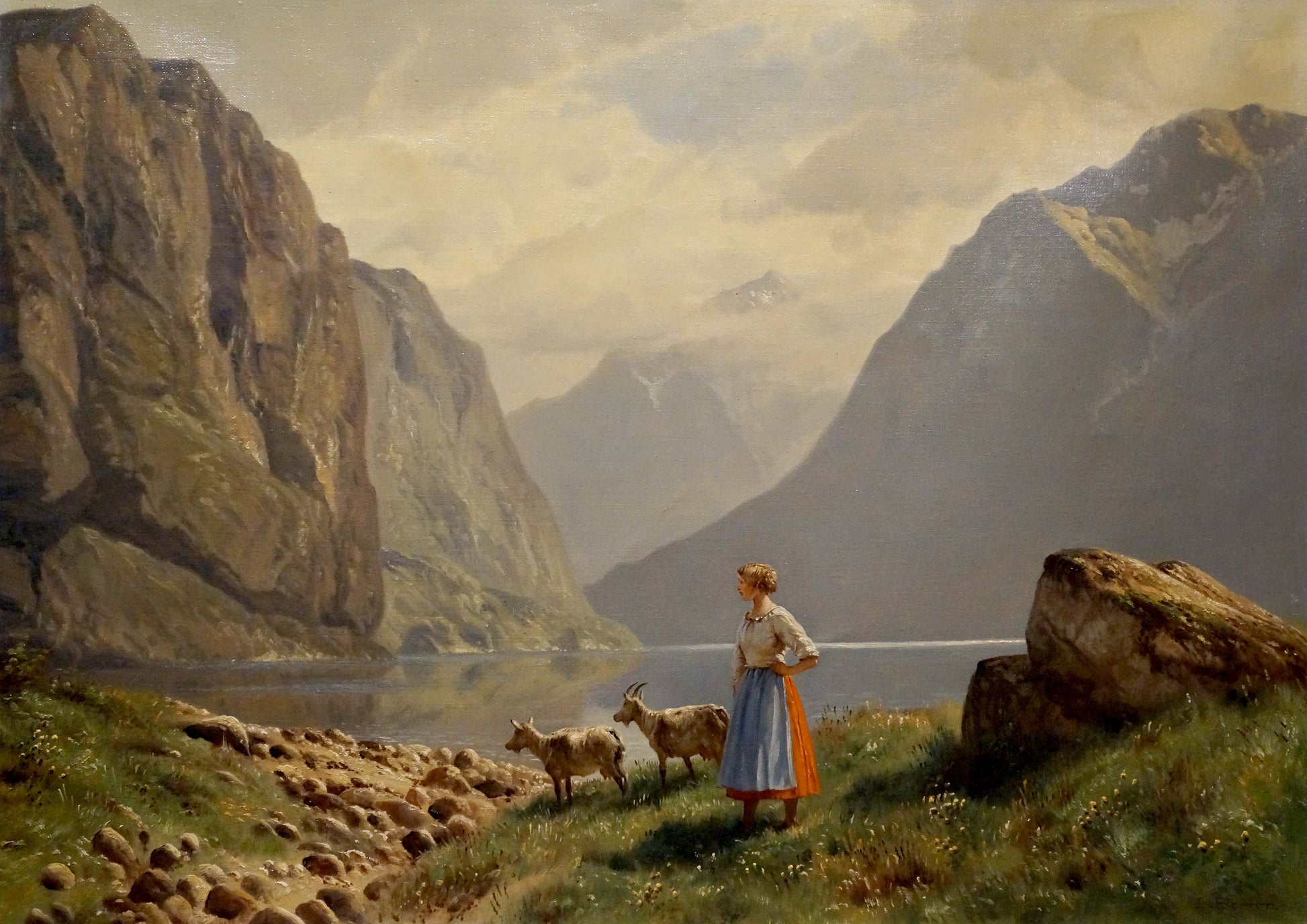 Oil painting by Louis Böhm: woman in blue skirt with goats by lake and cliffs