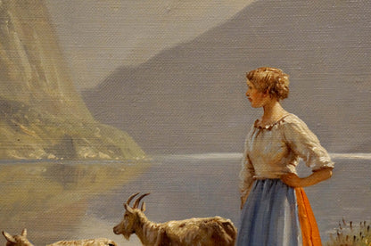 Oil painting by Louis Böhm: woman in white blouse, blue skirt, orange sash with goats by water