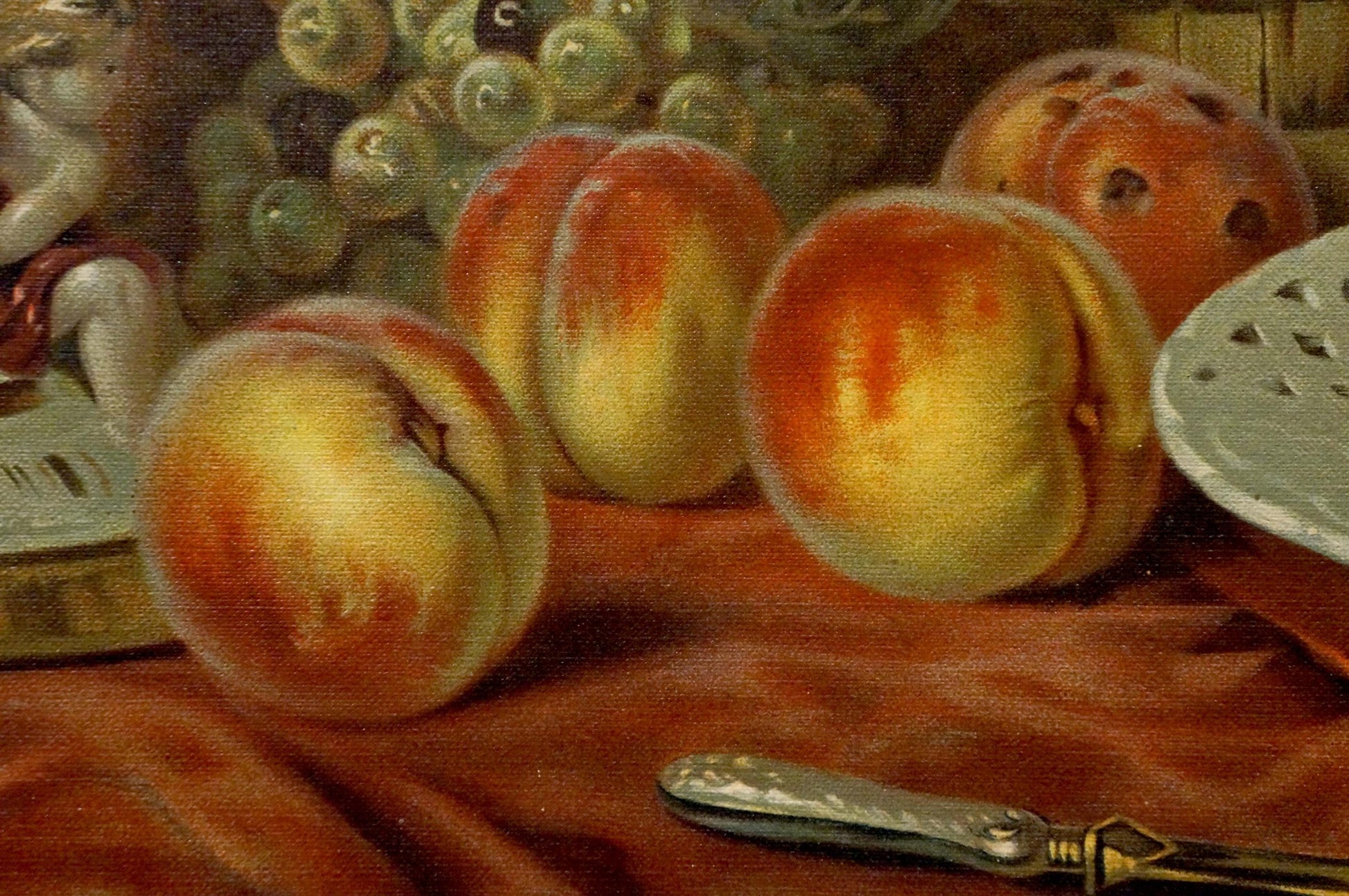 Oil painting of ripe peaches on red fabric in A sweet table is set