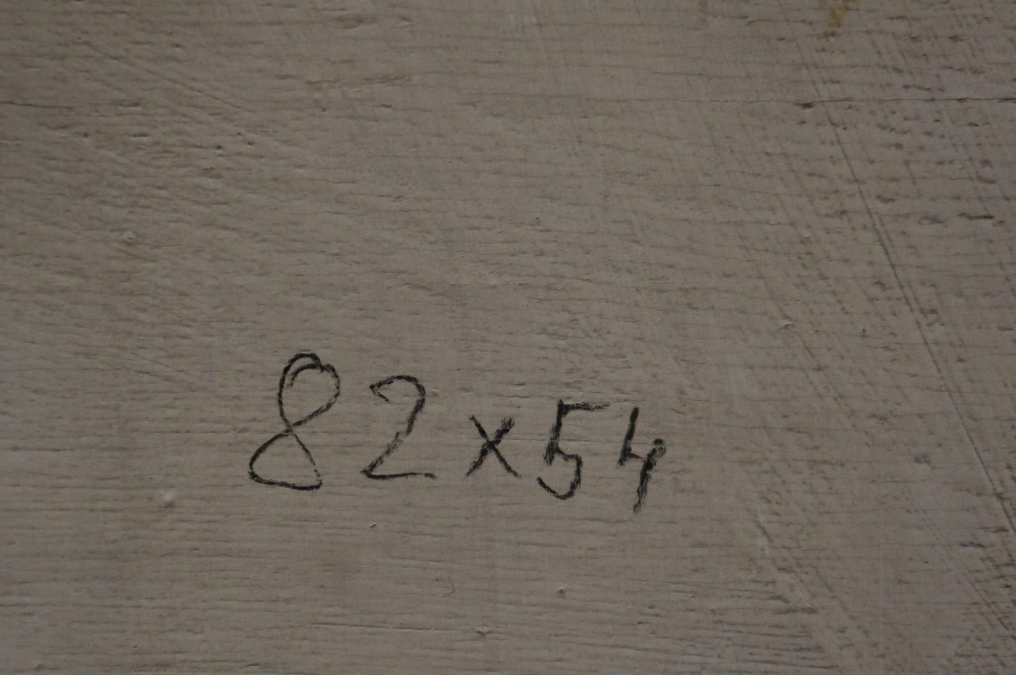 Back of Oil painting Flowers M. Eberhard with 82x54 inch marker notation on gray concrete