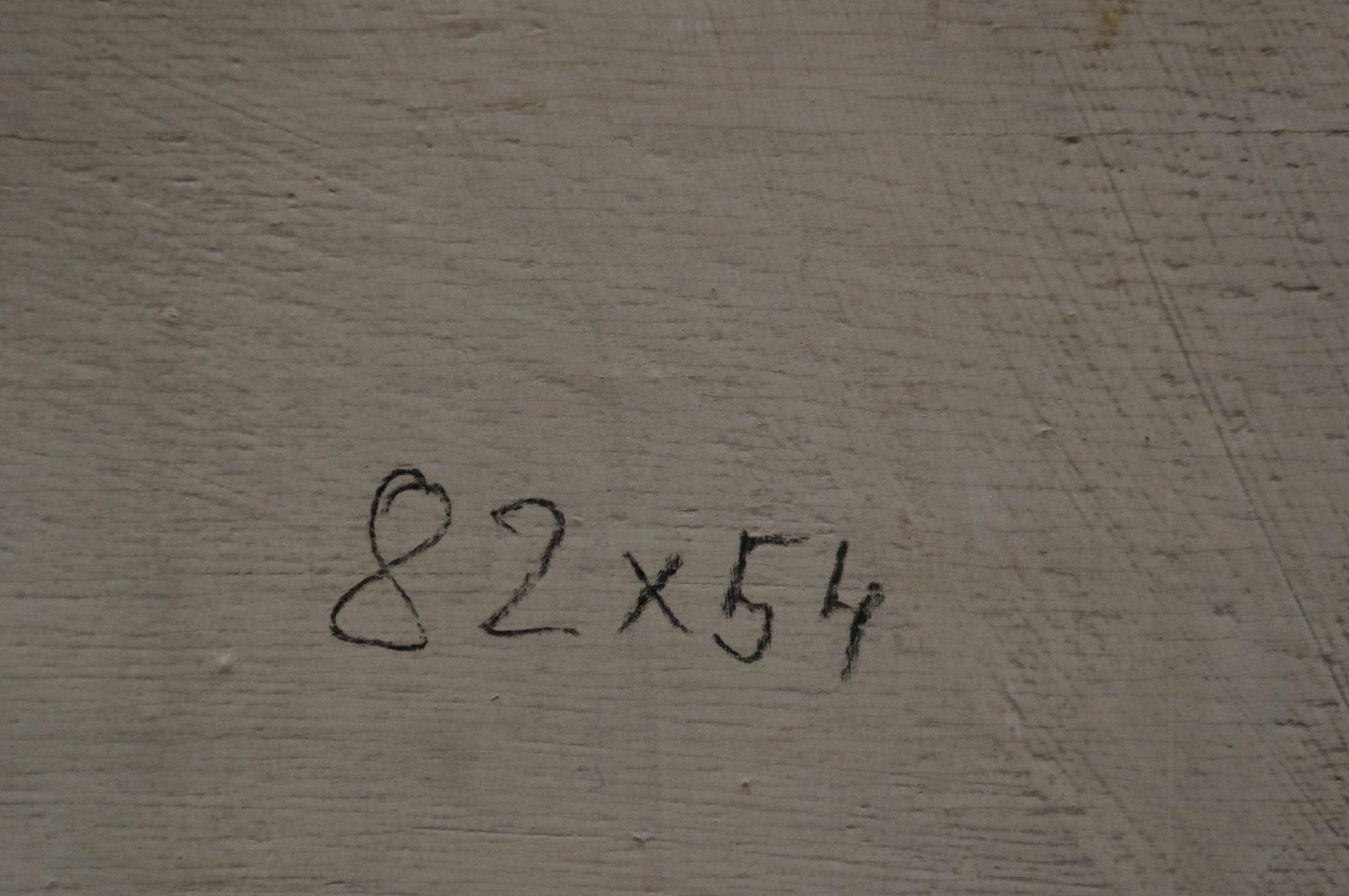 Back of Oil painting Flowers M. Eberhard with 82x54 inch marker notation on gray concrete