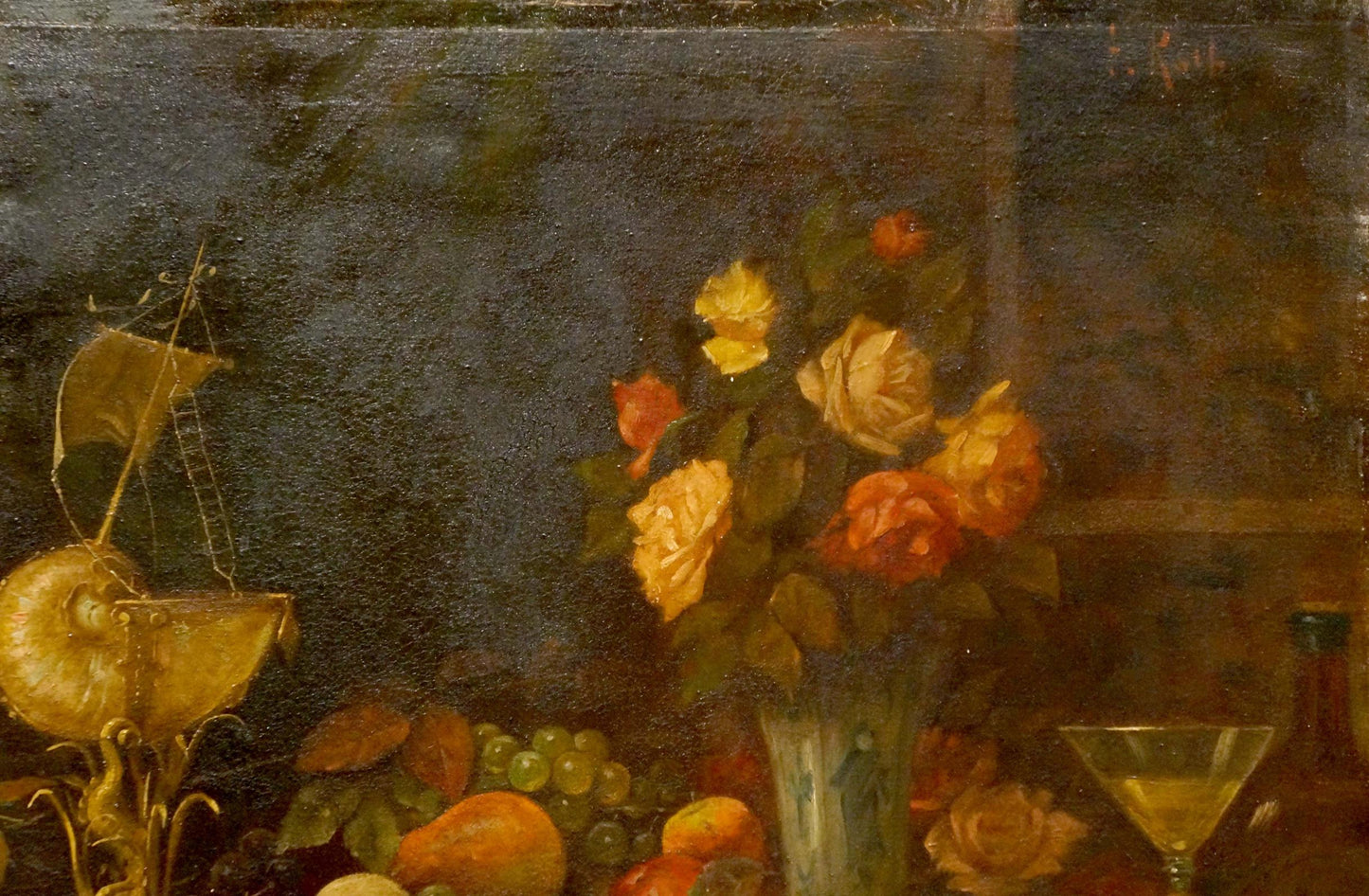 Golden nautilus shell with miniature sailboat atop oil painting