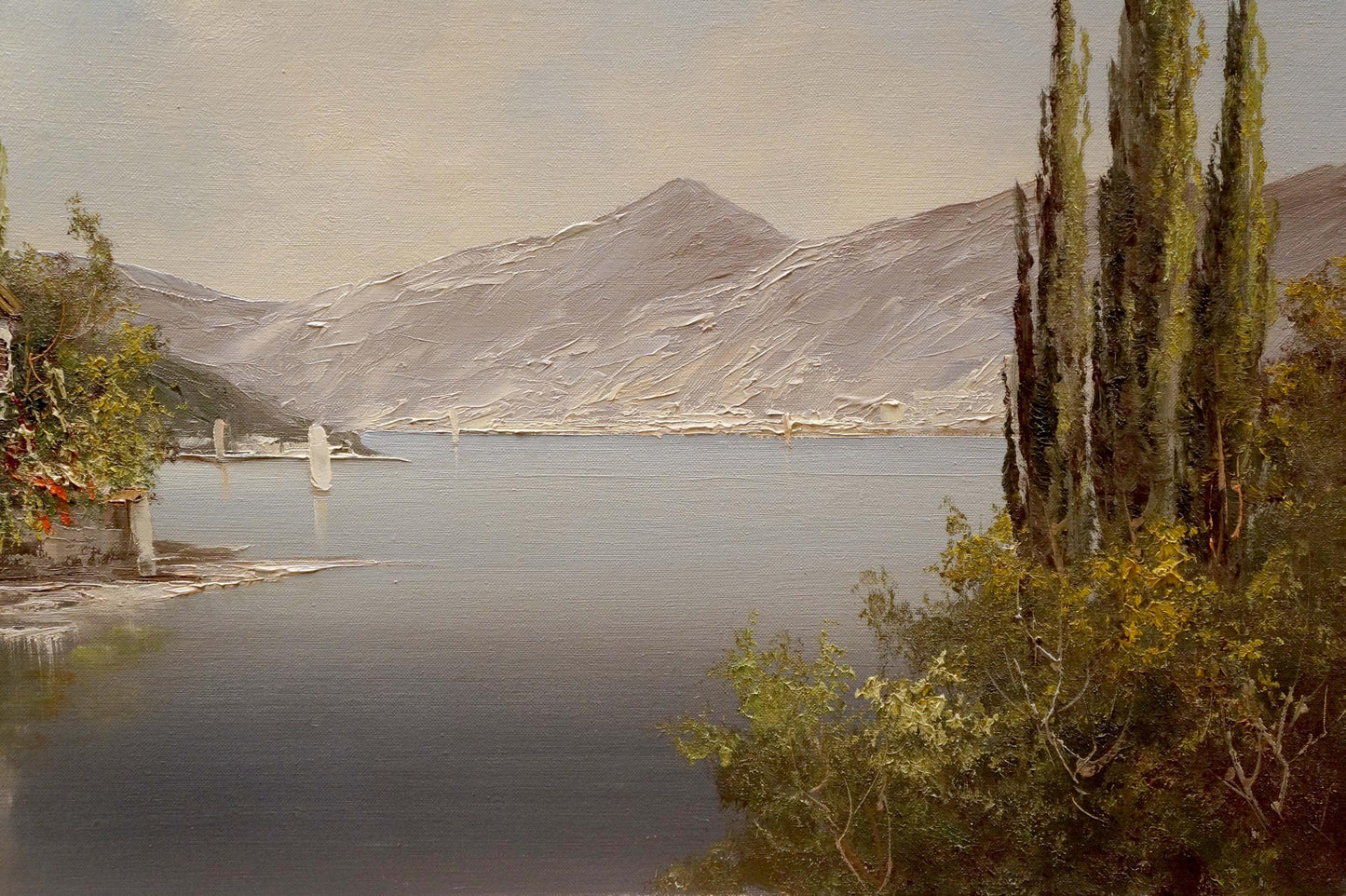 Serene oil painting of house by the shore lake with trees and mountains by Bruno Martini