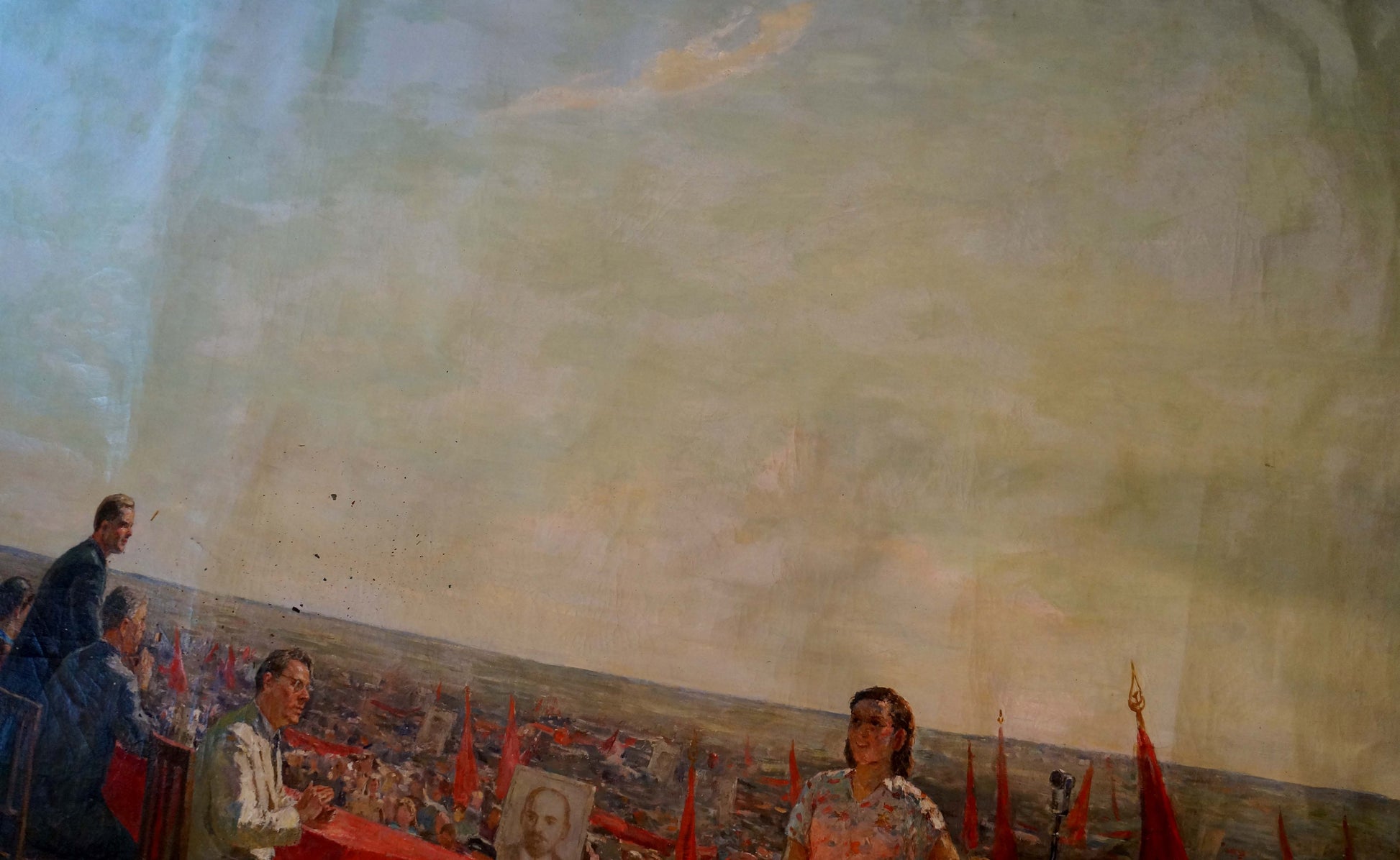 Oil painting by Petr Kuzmich Stolyarenko: rally over cityscape with red flags