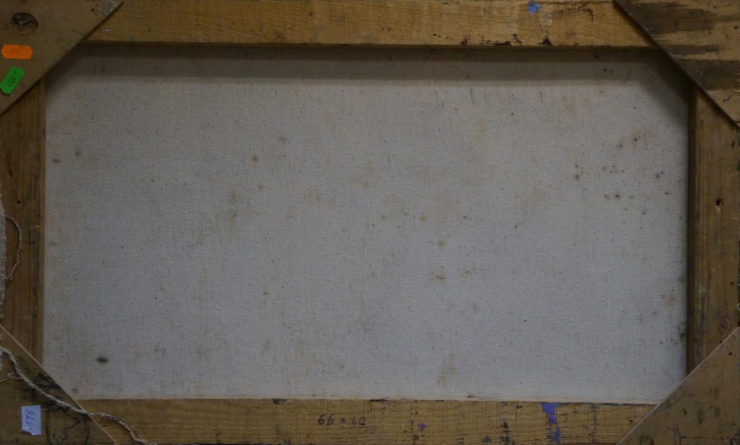 Back of weathered wooden-framed Oil painting Lilac joy on the table