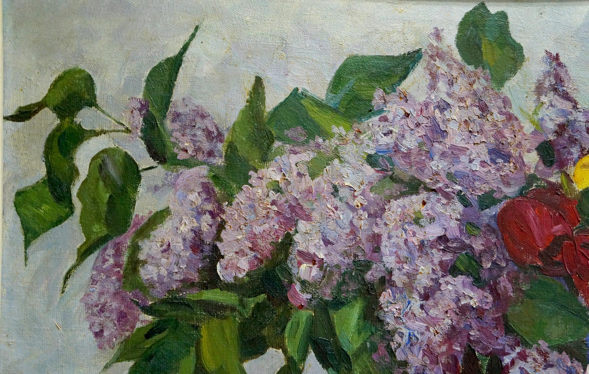Oil painting of lilacs and tulips in vase with lush green leaves