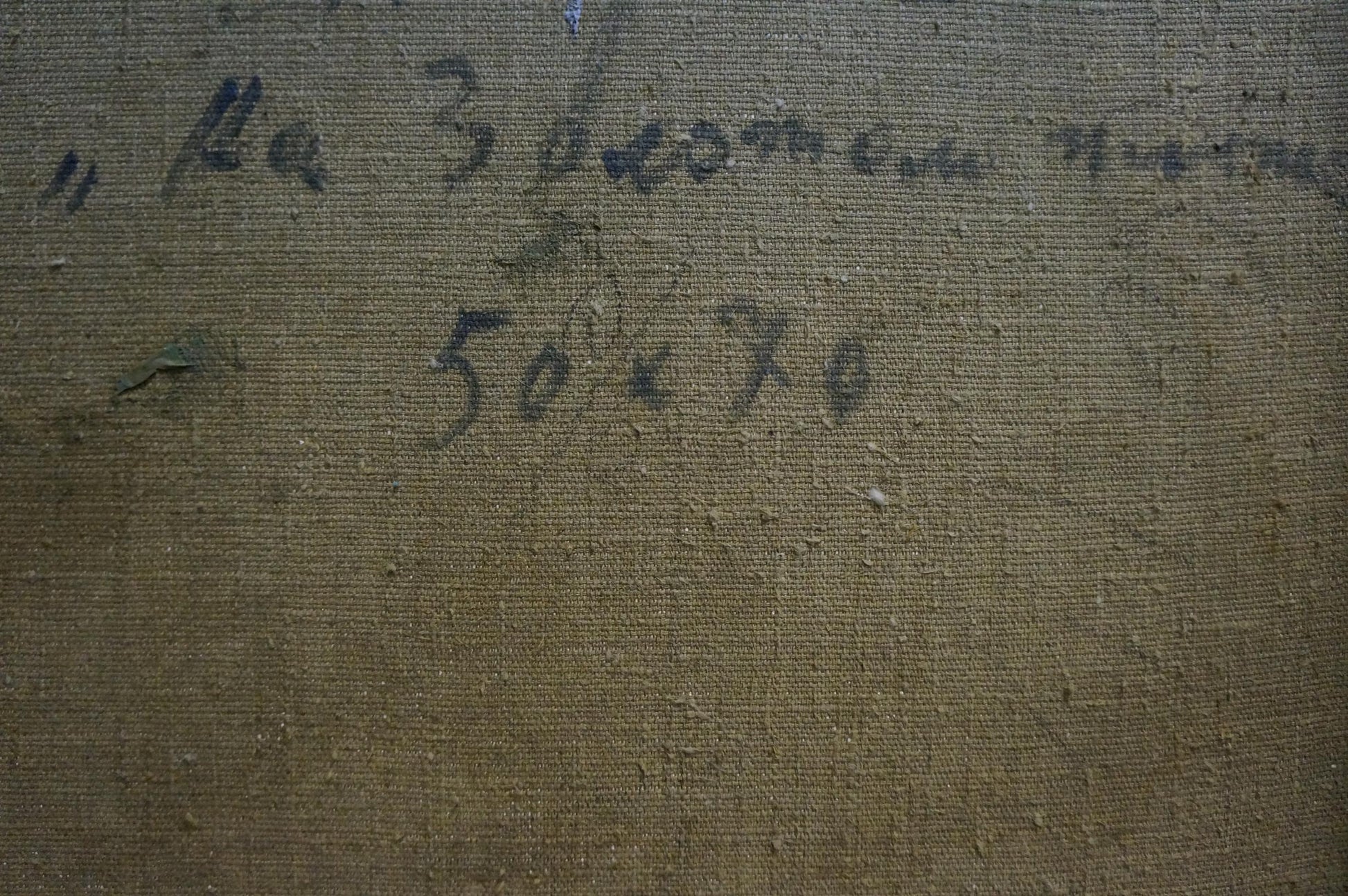 Back of Oil painting Near the sea Strelov Arkady Efimovich on dark brown woven fabric with faded blue text