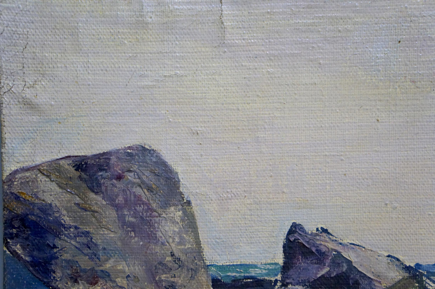 Oil painting Craggy Seashore by Stepan Yarovoy: gray purple rocks on pale sky