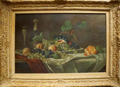 Ornate oil painting by Schlieden M: grapes, peaches, orange blossom, wine bottle on table