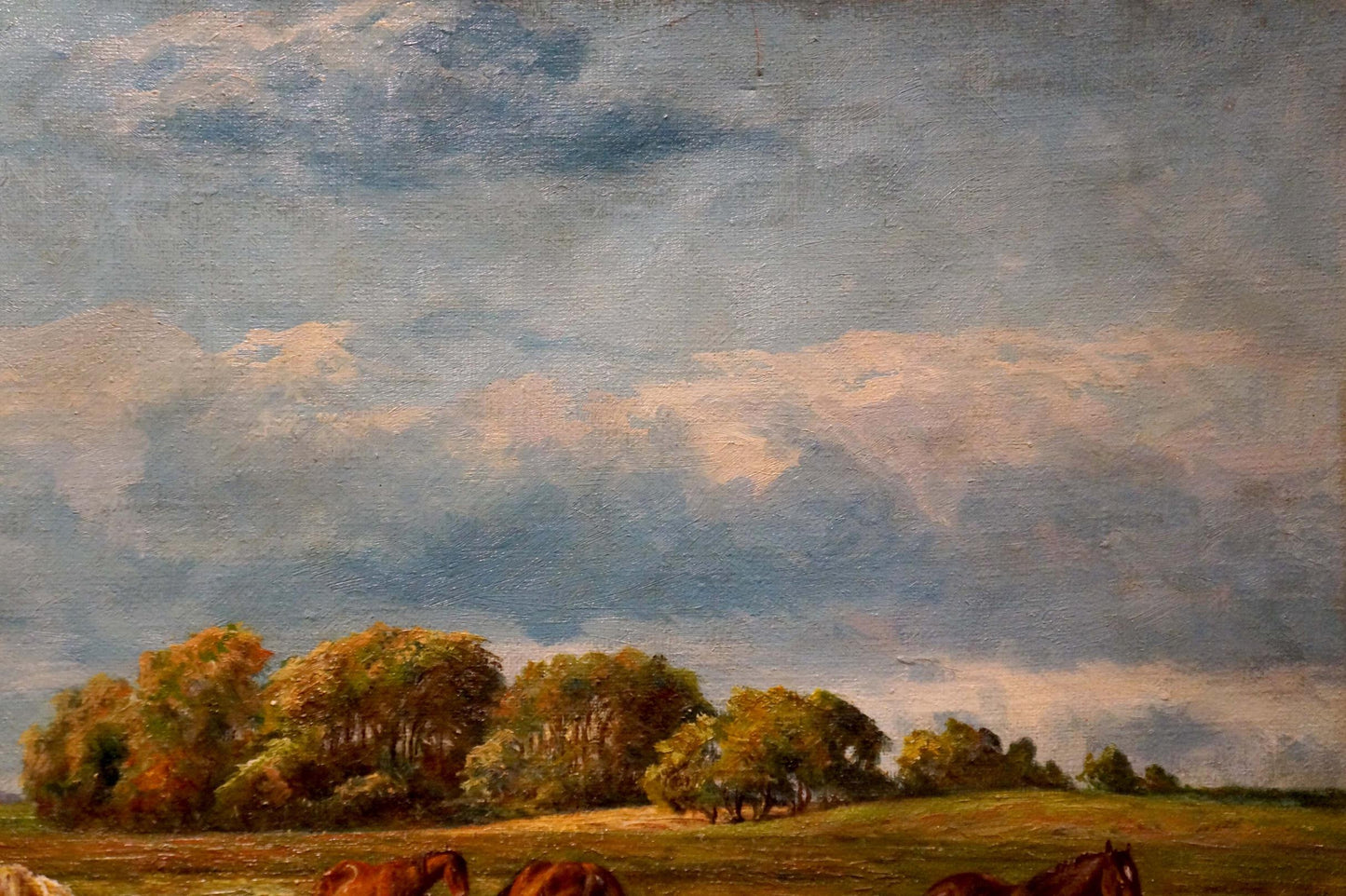 Oil painting of horses grazing under autumn trees and blue sky