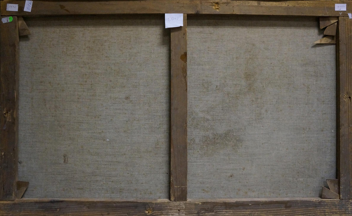 Back view of two-panel wooden-framed canvas with gray textured fabric, Ship at sea oil painting