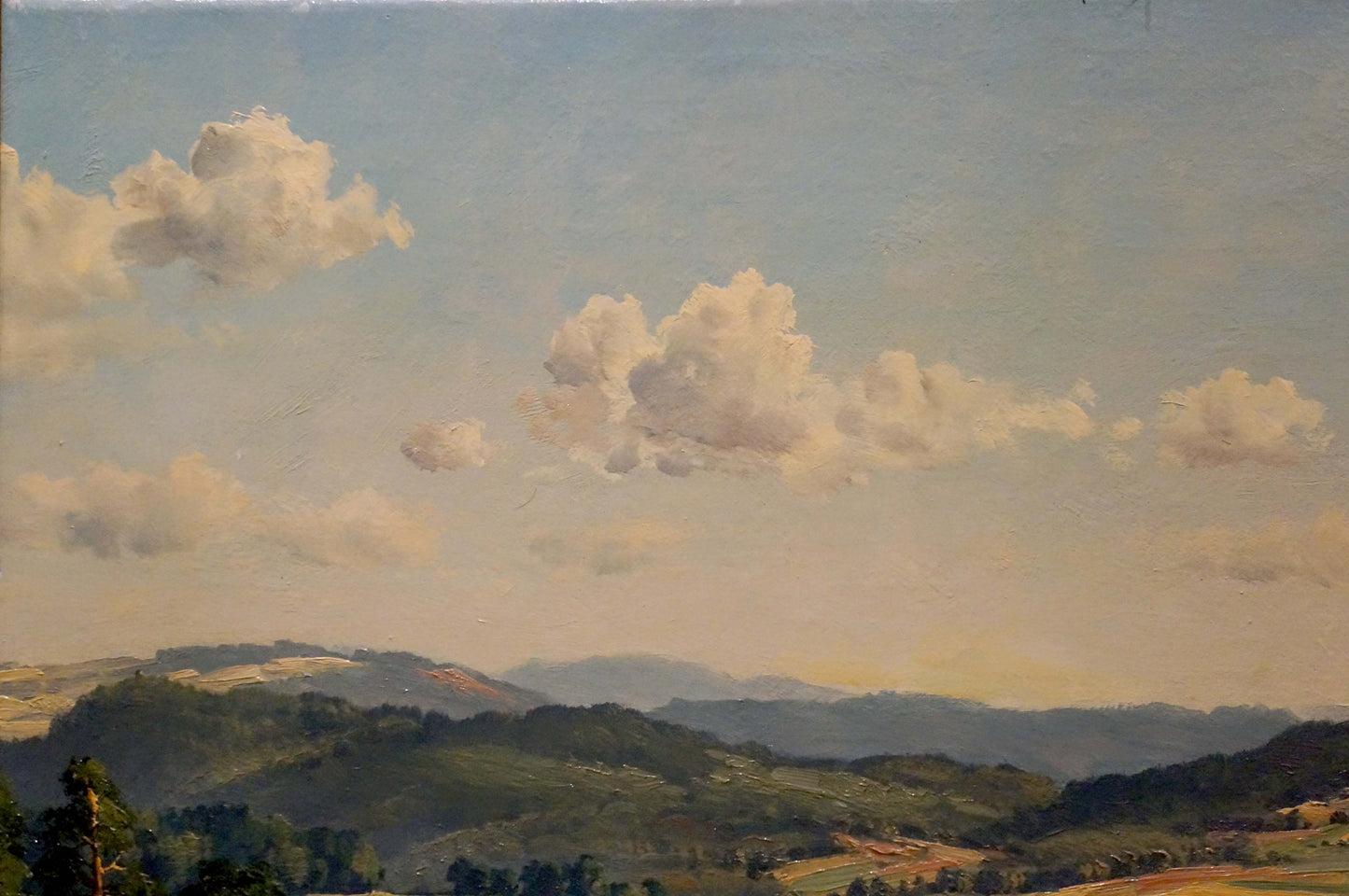 Oil painting landscape with field: serene green hills under blue sky with clouds