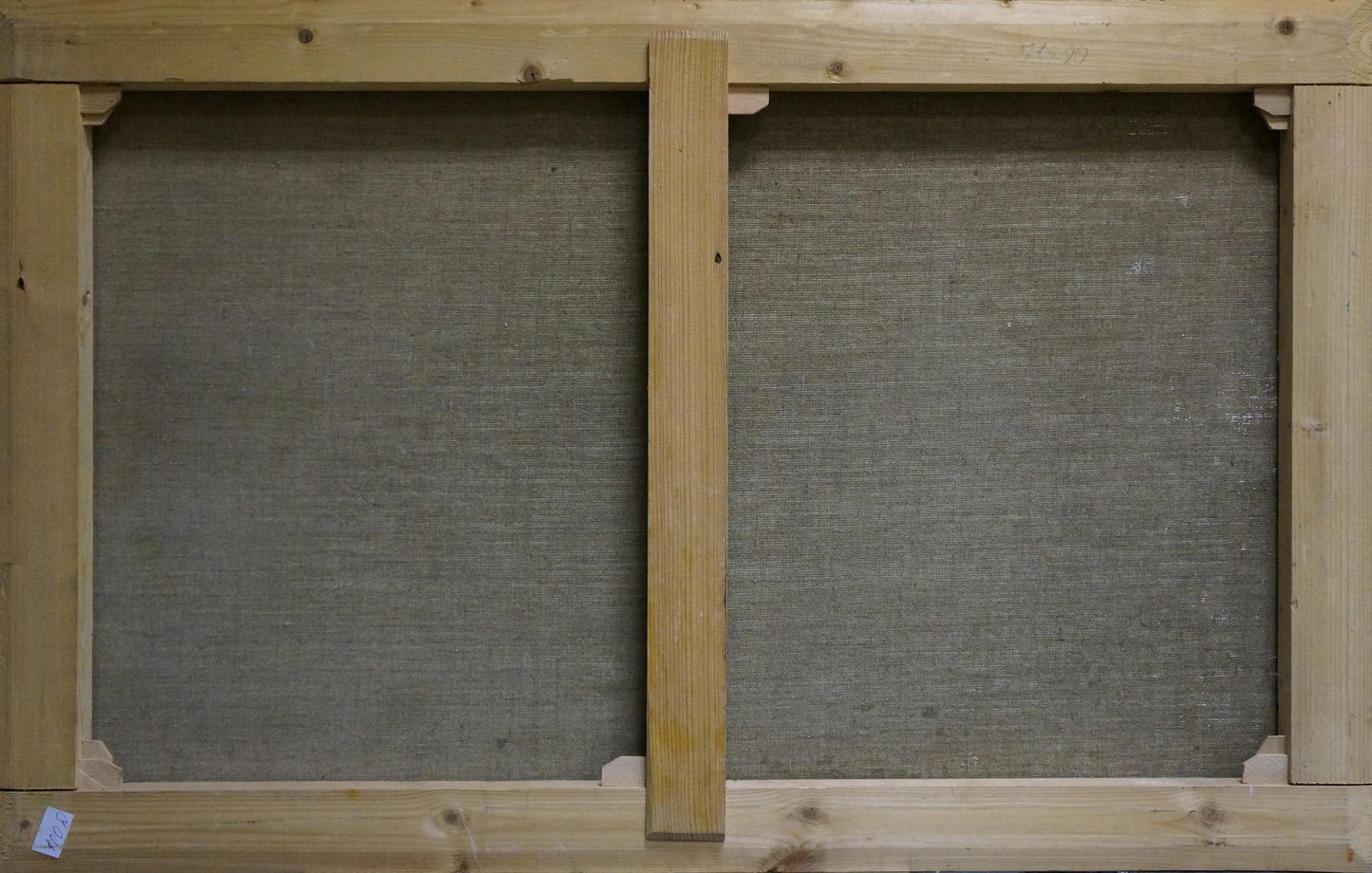 Back of light wood stretcher frame with gray canvas panels for Babynets mountain oil painting