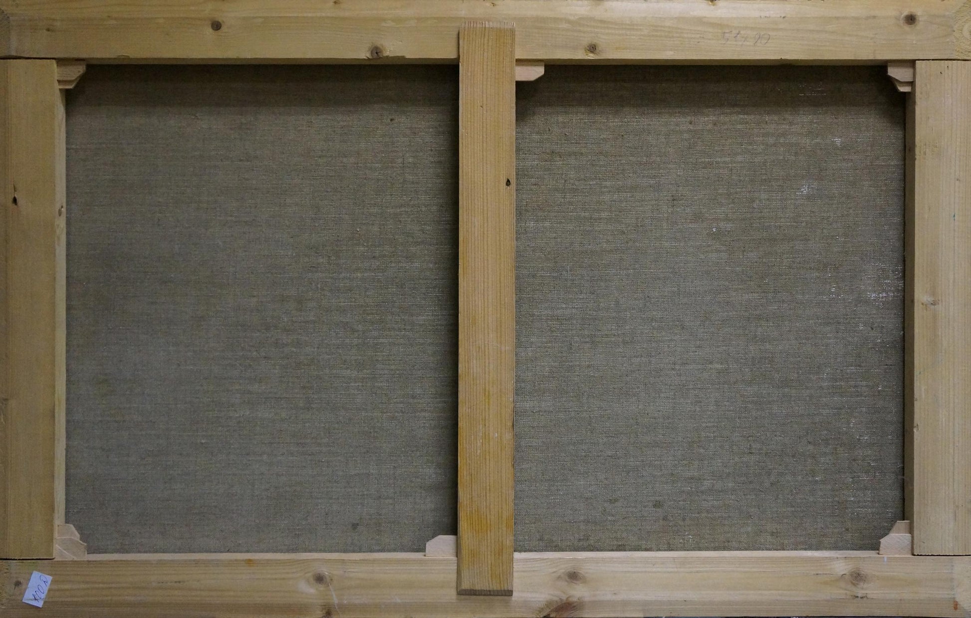 Back of light wood stretcher frame with gray canvas panels for Babynets mountain oil painting