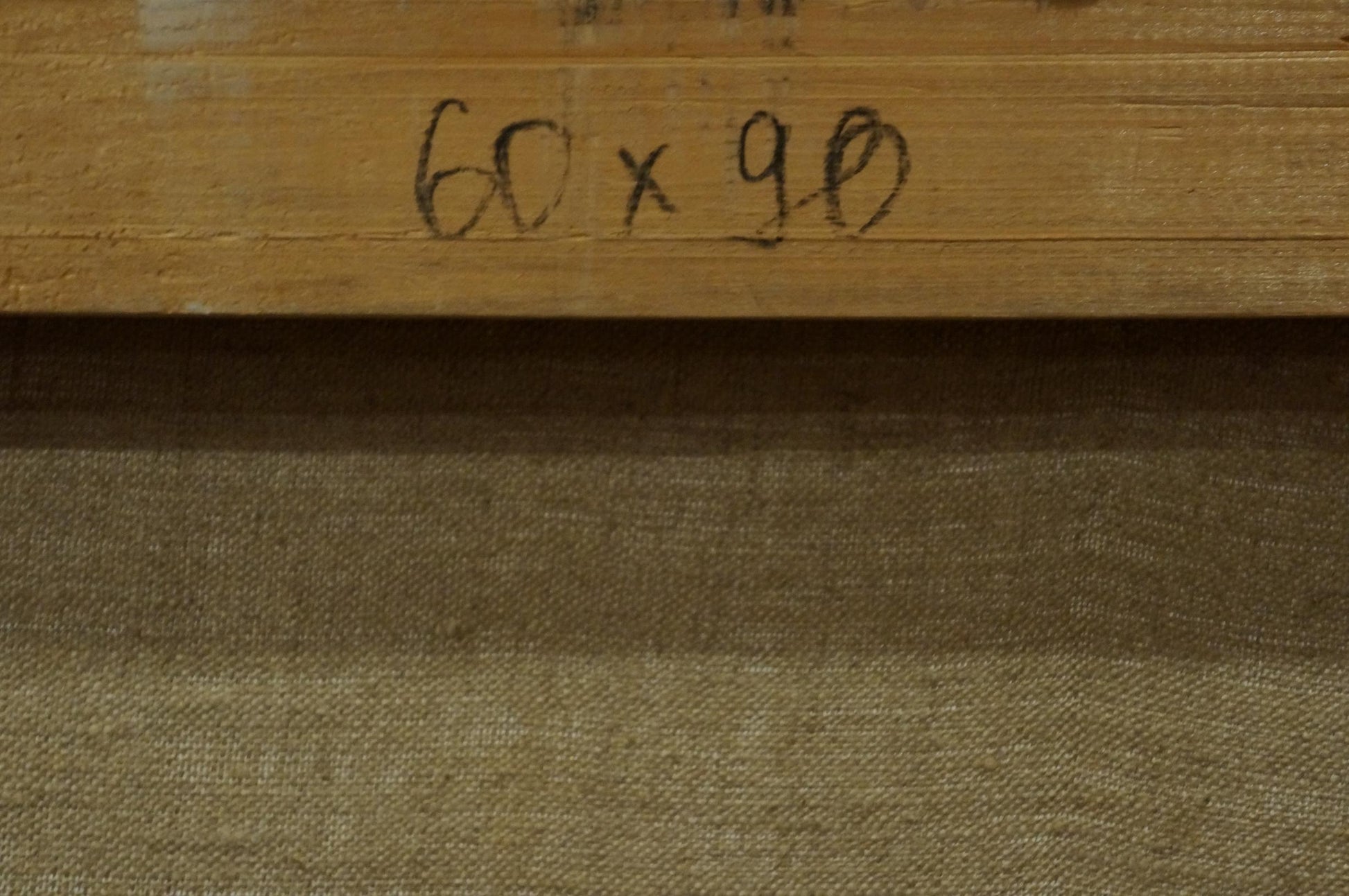 Back of Mysterious Winter Forest Albert oil painting frame with handwritten 60 x 90 in black ink on light brown wood