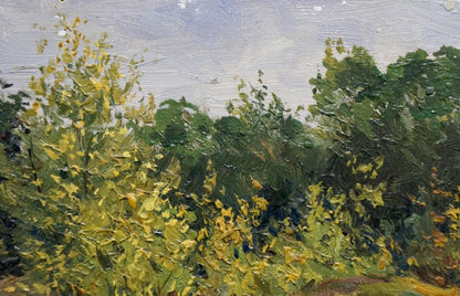 Oil painting by Petr Chernyshevsky: yellow flowers on wooded hill under cloudy sky