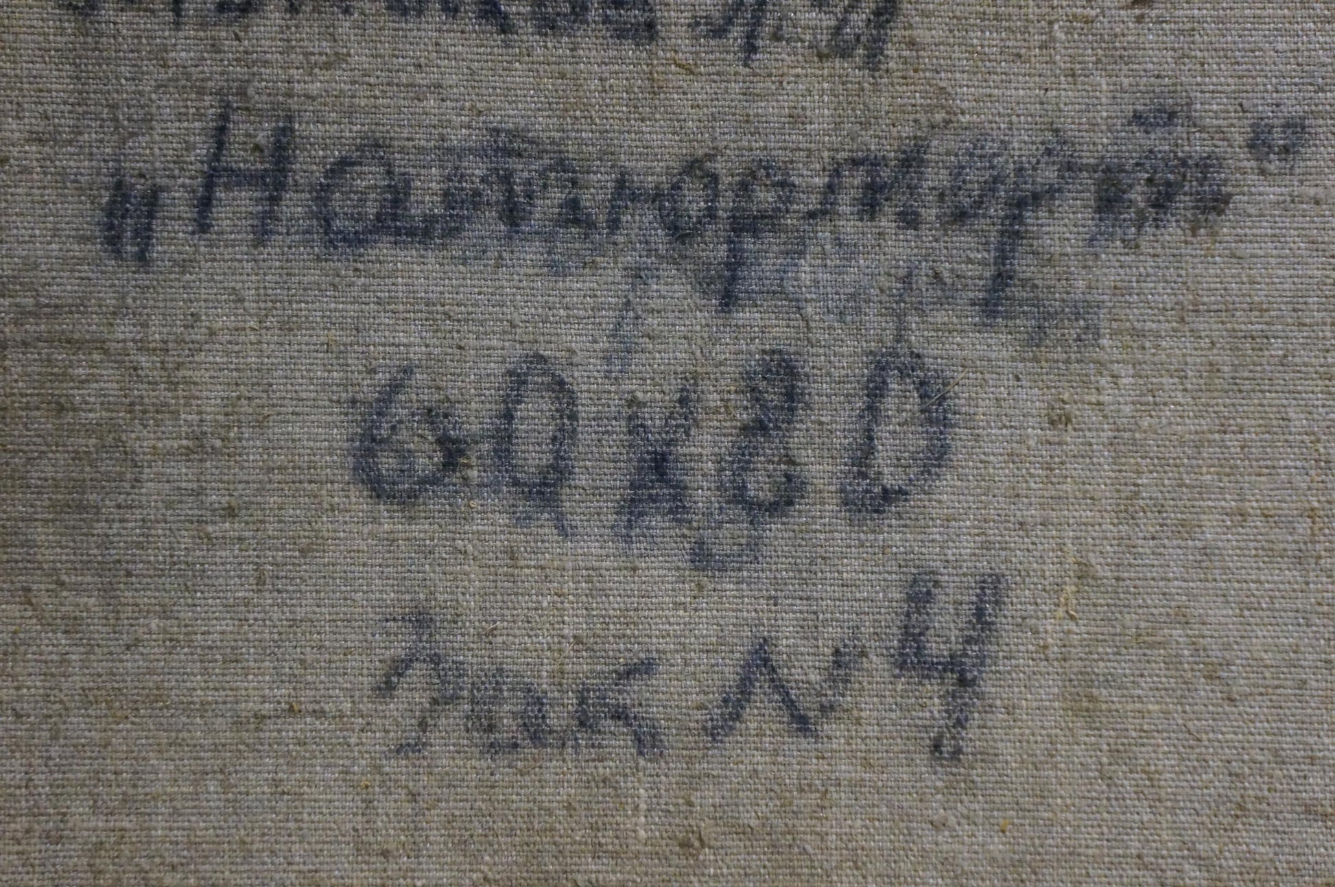 Faded blue handwritten text on gray fabric back of Monakhov Lev Ivanovich oil painting
