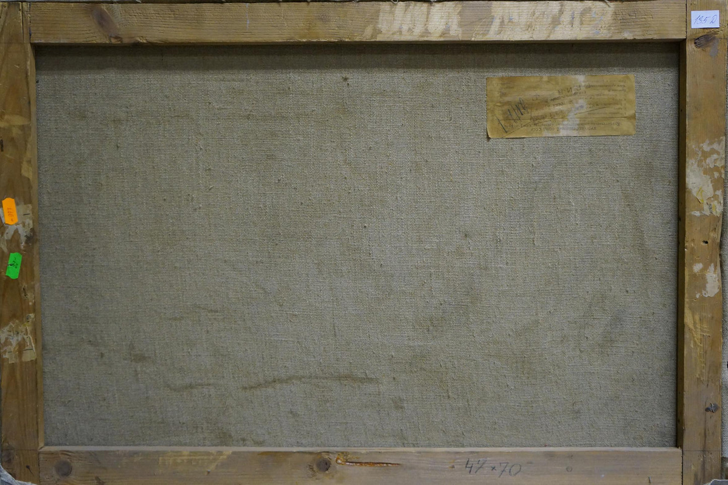 Back of large oil painting canvas: snowdrifts in forest, worn gray fabric backing