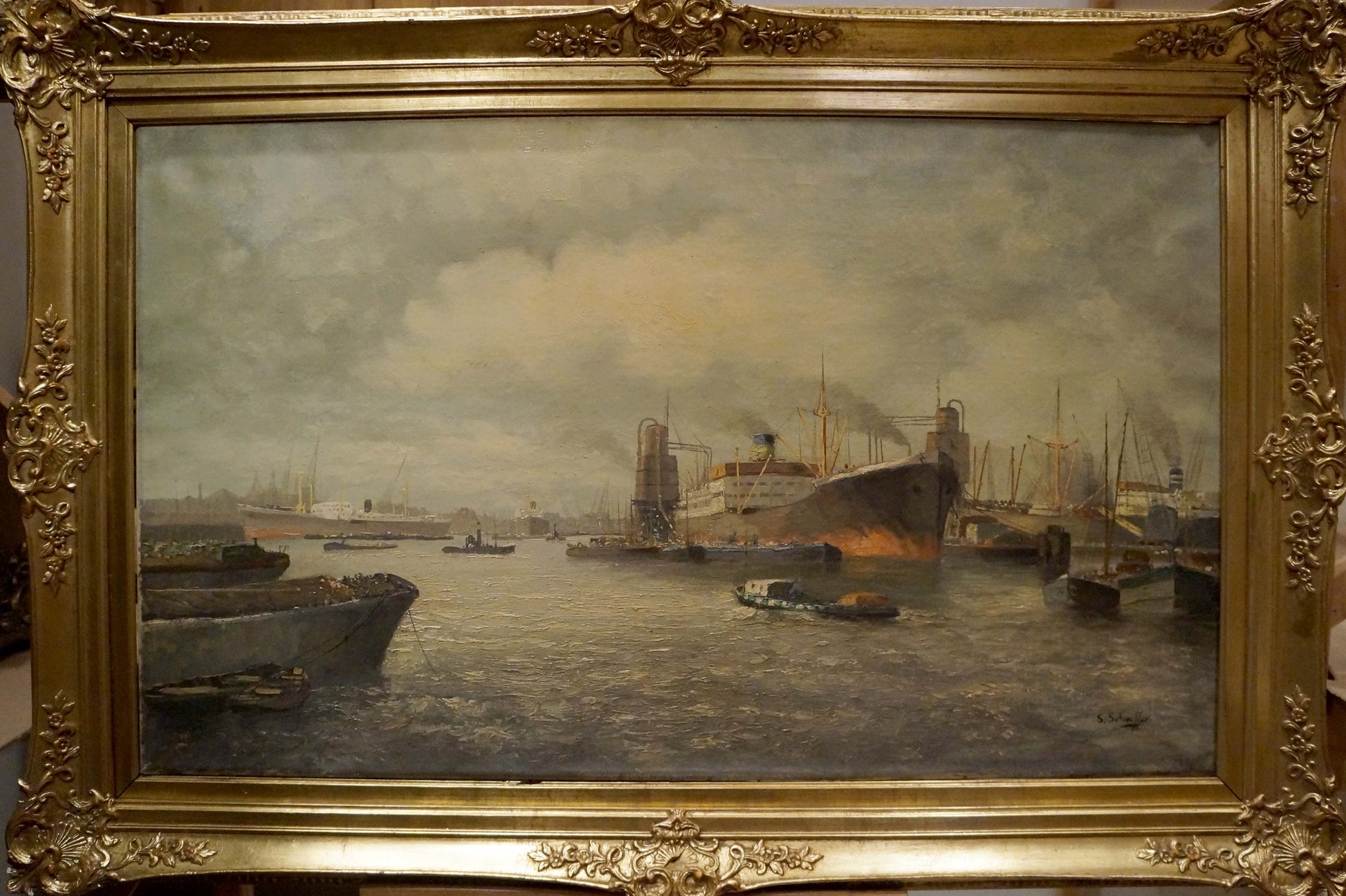 Ornate gold-framed oil painting of bustling harbor with ships under overcast sky