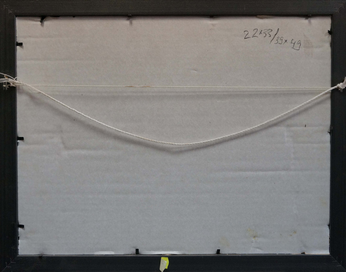 Back of Oil painting In the village with black frame, white backing, thin off-white string