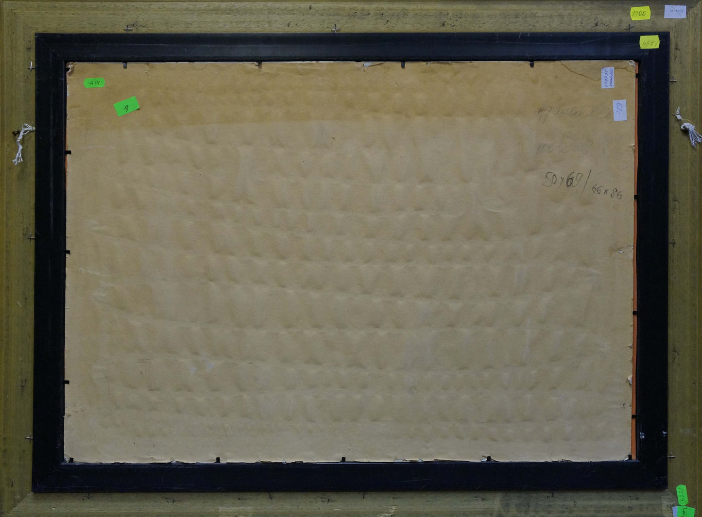 Back of black framed Oil painting Boat in port Afanasyev Vladimir Nikolaevich canvas with beige textured backing and green sticky notes on corners
