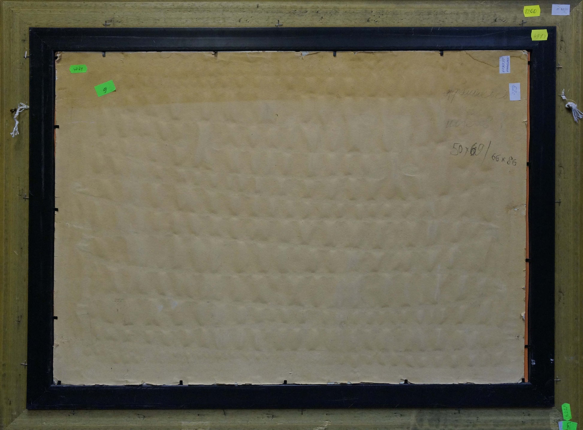 Back of black framed Oil painting Boat in port Afanasyev Vladimir Nikolaevich canvas with beige textured backing and green sticky notes on corners