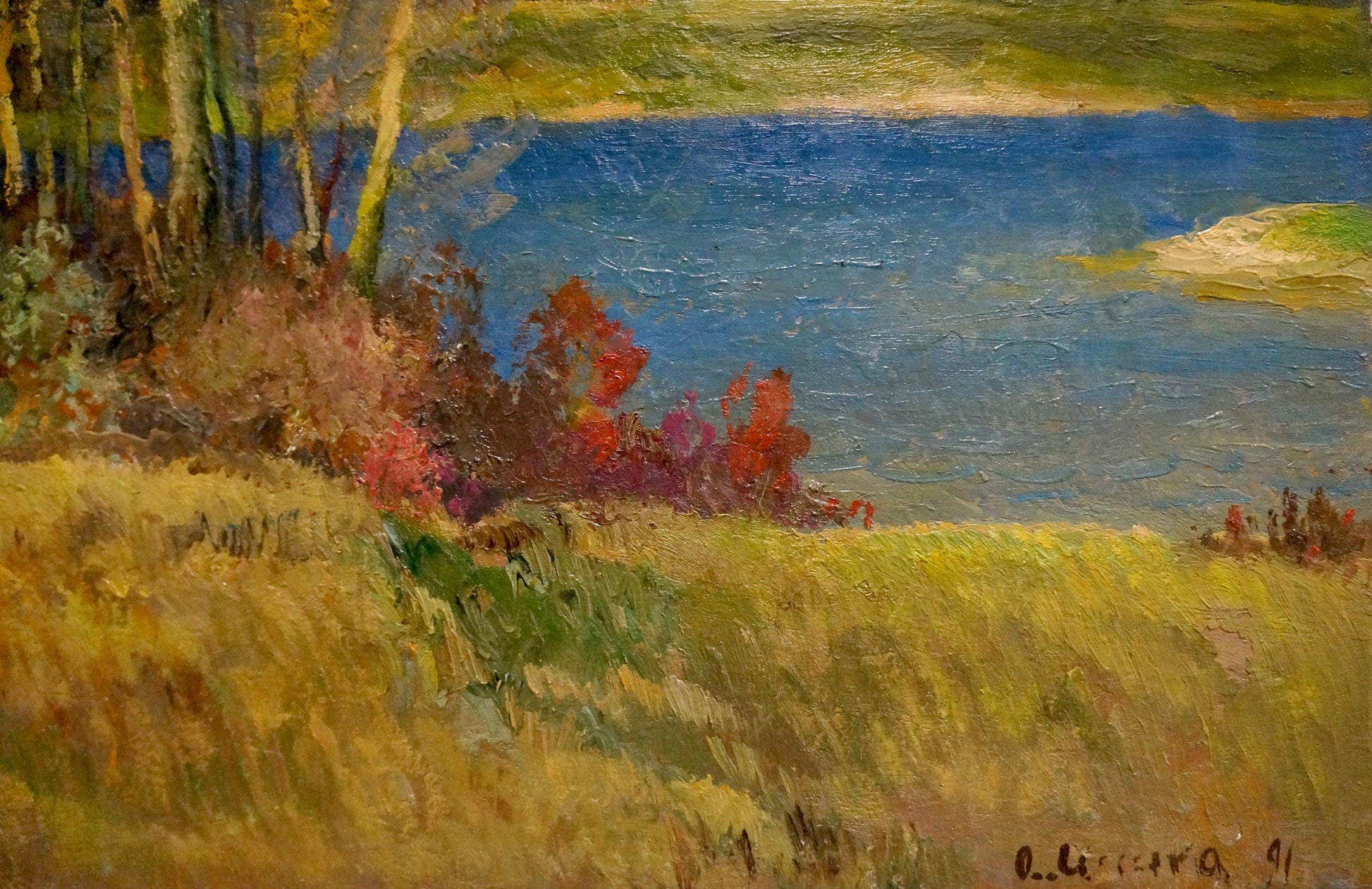 A vibrant impressionist painting depicting a serene lakeside scene with golden grasses, autumnal trees in red and purple hues, and deep blue water under soft green hills.