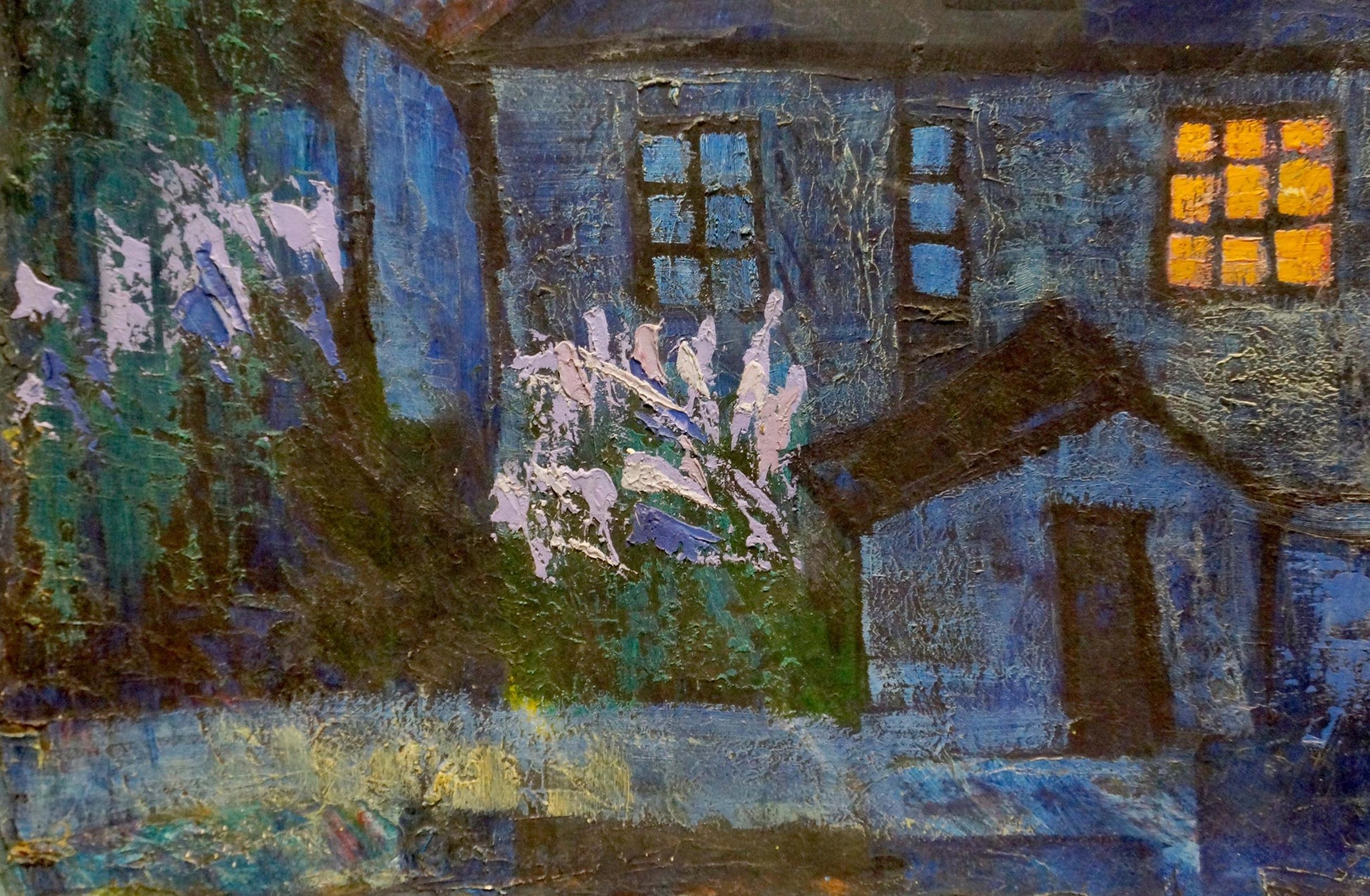 Oil painting night landscape: textured blue house with glowing yellow window, white flowering bushes