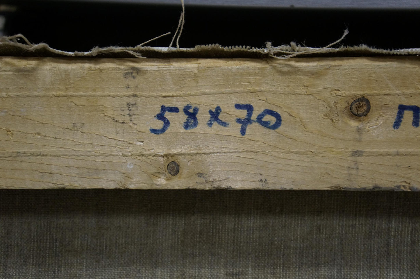 Back of Oil painting Near the forest Mynka Alexander Fedorovich: weathered wooden beam with rusted screws and blue markings