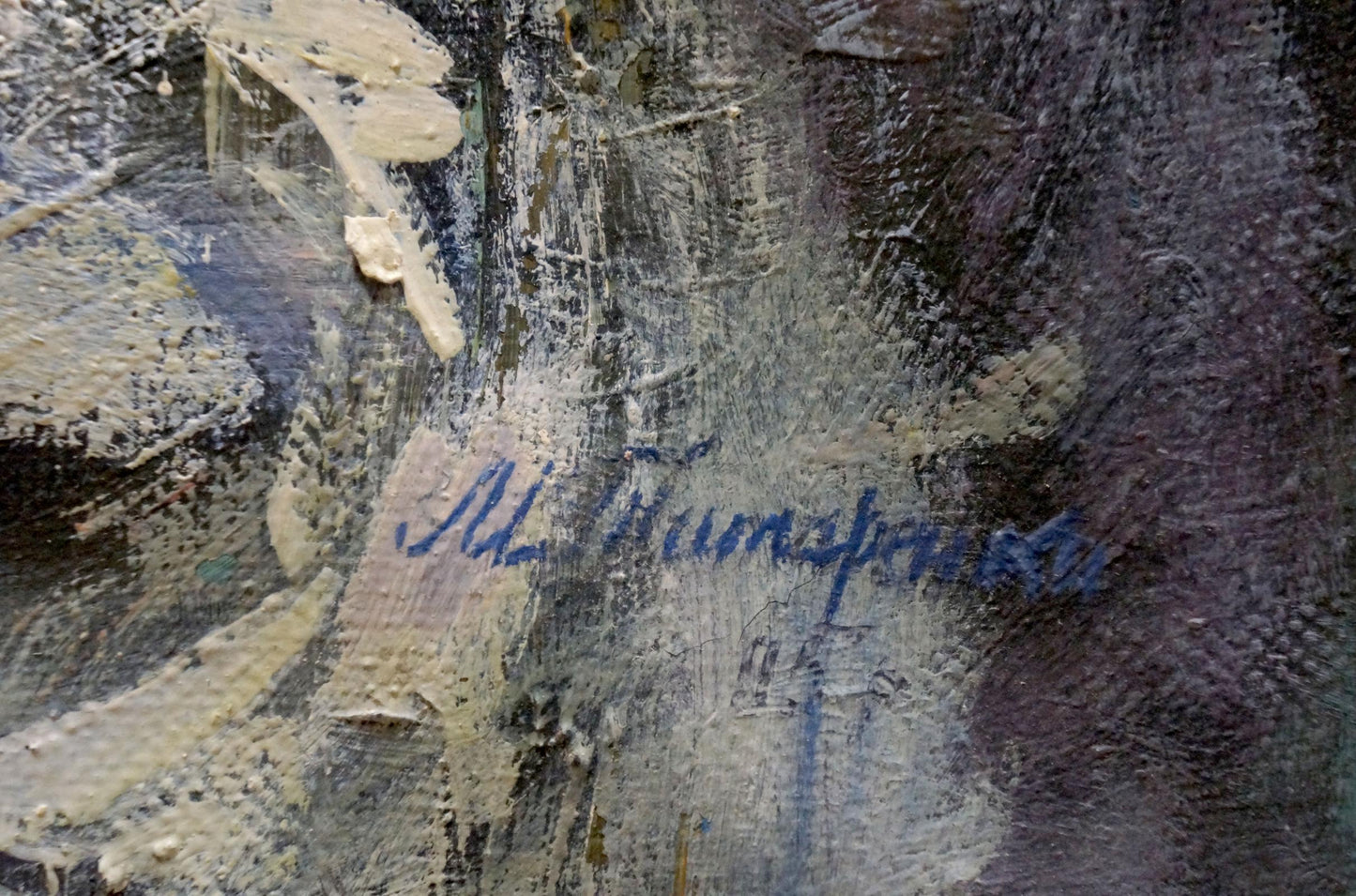 Blue cursive signature of Tytarenko Odarka Anatoliivna on textured dark oil painting back