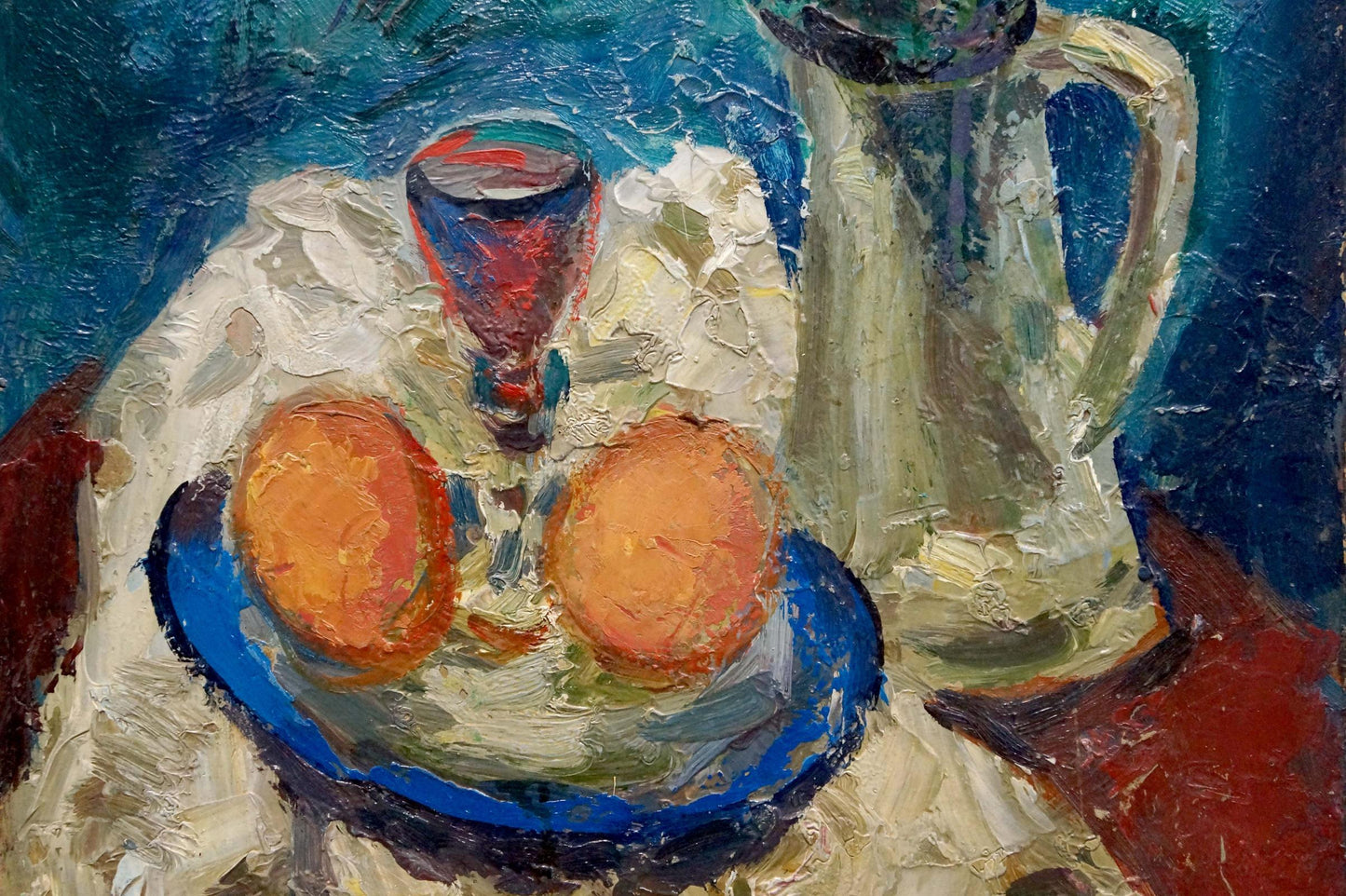 Oil painting Still life Karelin Vyacheslav: blue plate with two orange fruits on textured fabric