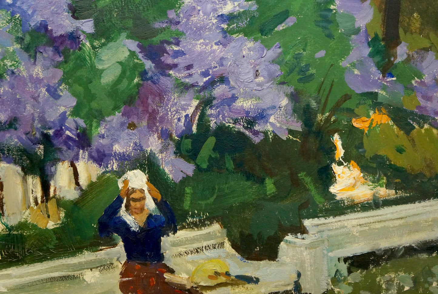 Oil painting Among the Lilacs by Gulyayev A.G.: woman in blue top and red skirt under purple lilacs