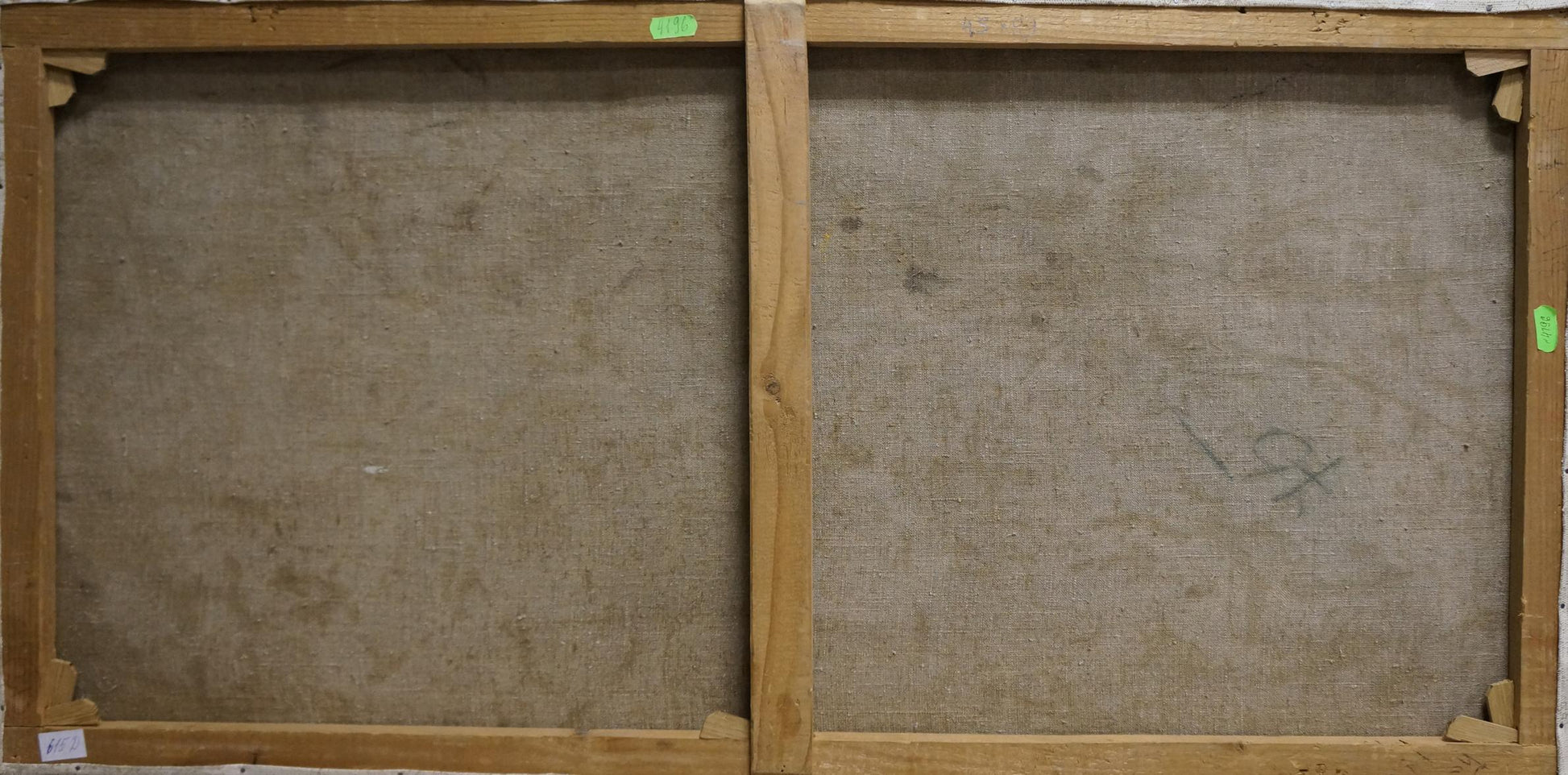 Back of two wooden-framed oil painting portraits of young figures with green labels