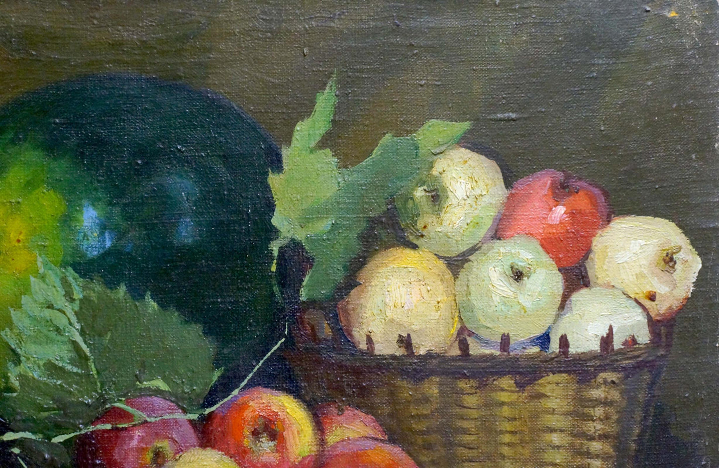 Oil painting of woven wicker basket with red yellow green apples