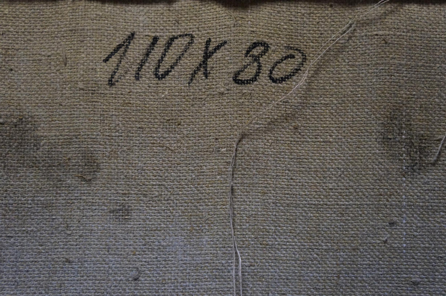 Back of Odarka Tytarenko oil painting with faded 10x30 stitched canvas