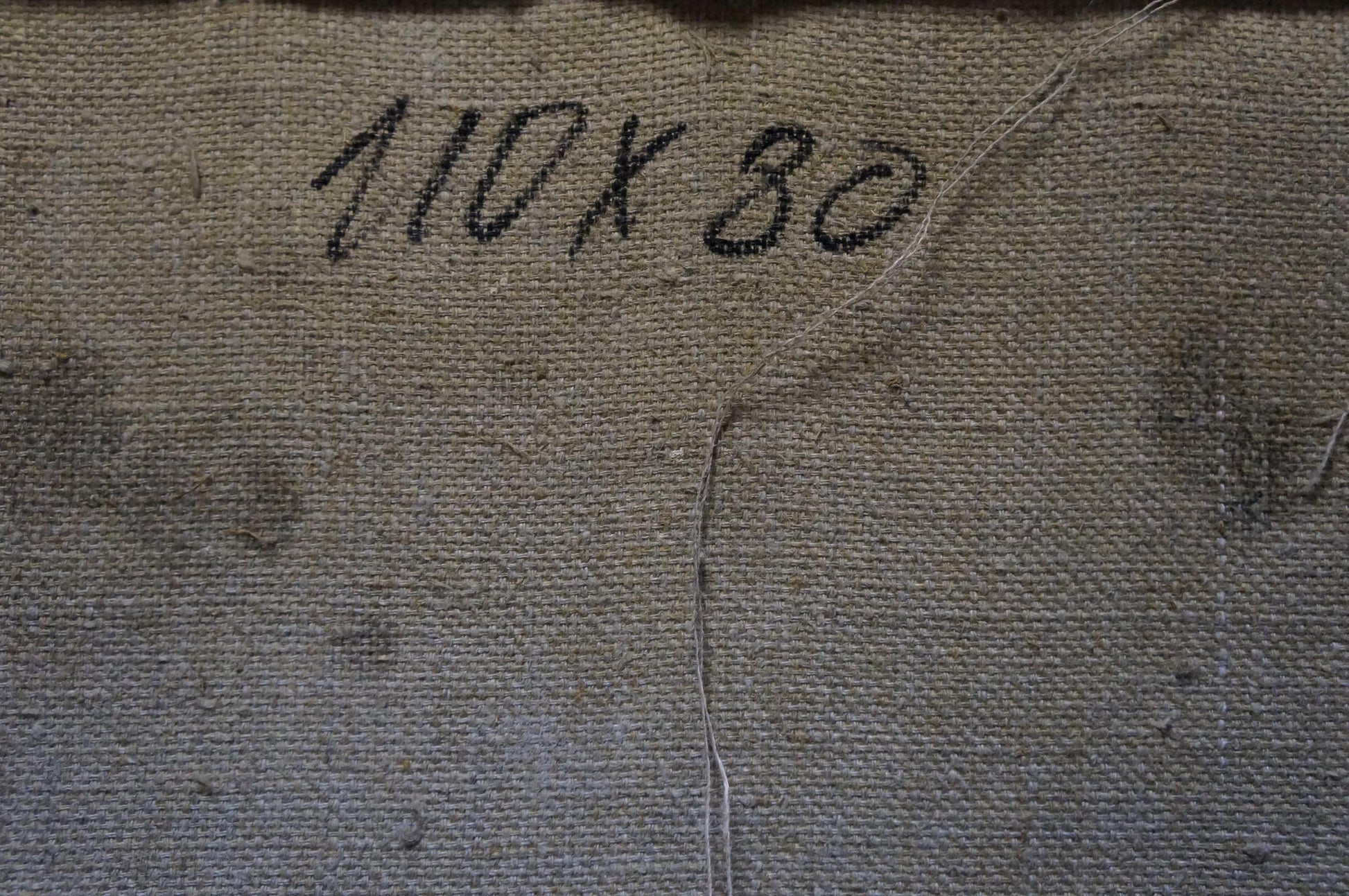 Back of Odarka Tytarenko oil painting with faded 10x30 stitched canvas
