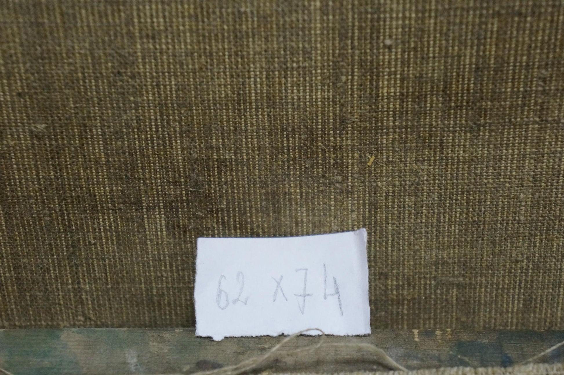 Handwritten label on olive-green fabric back of Sergey Dupliy winter city oil painting