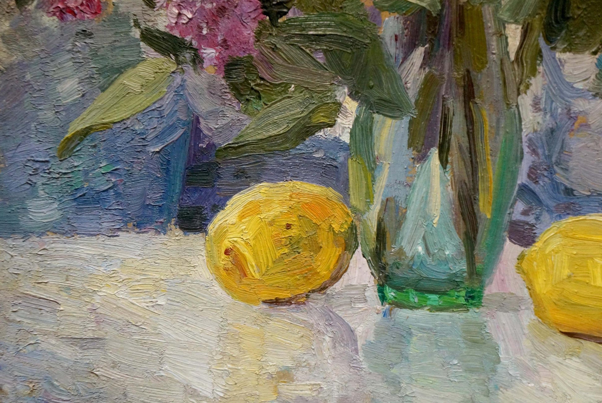 Oil painting of lilacs and tulips on table with yellow lemon and green vase
