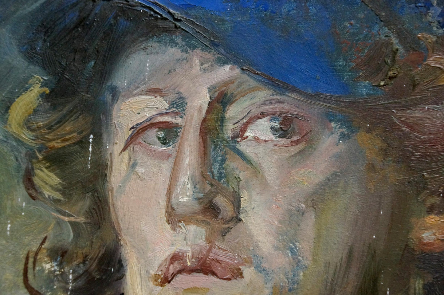 Textured oil painting portrait of the artist with expressive eyes