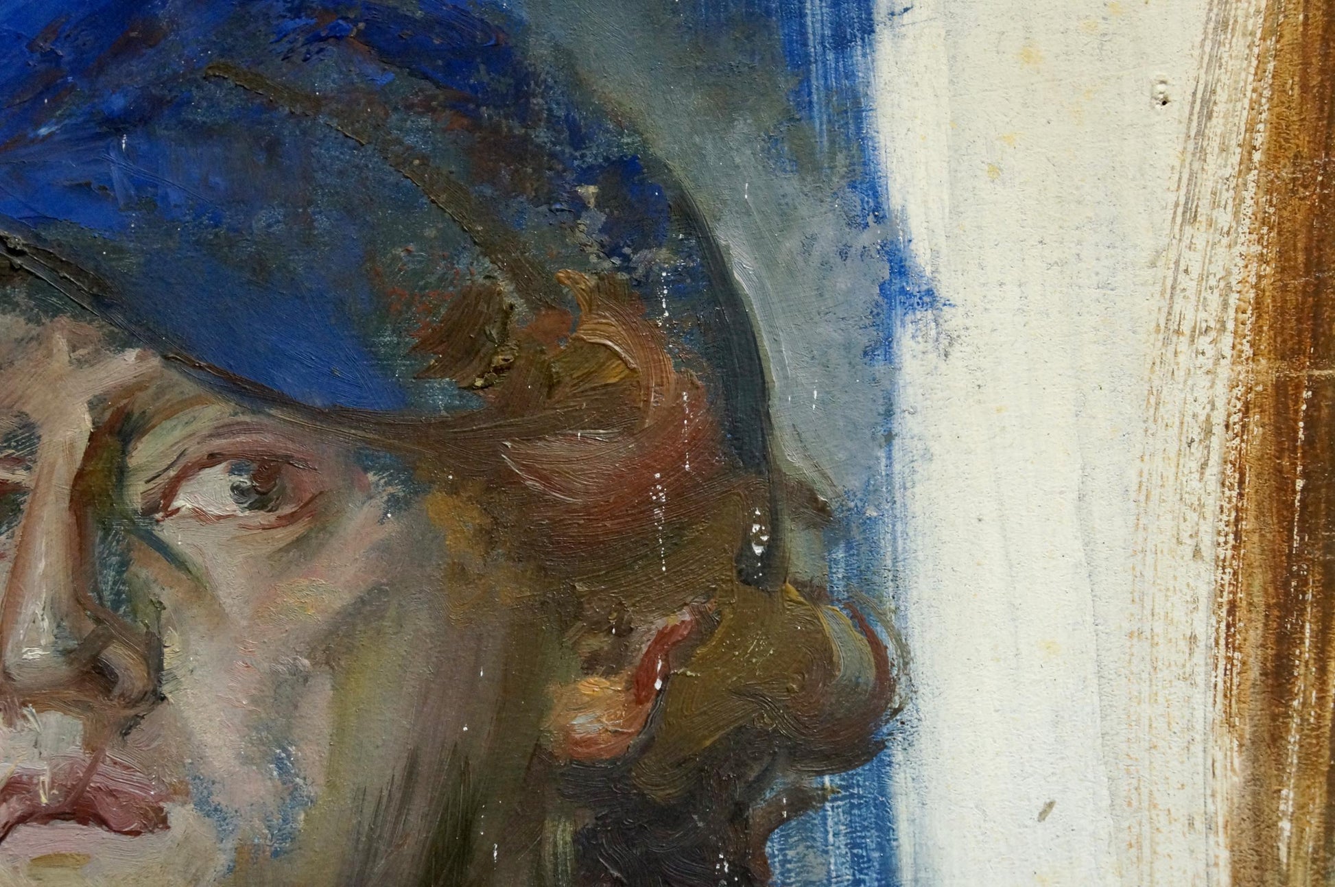 Oil painting portrait of artist with expressive eyes in blue hat