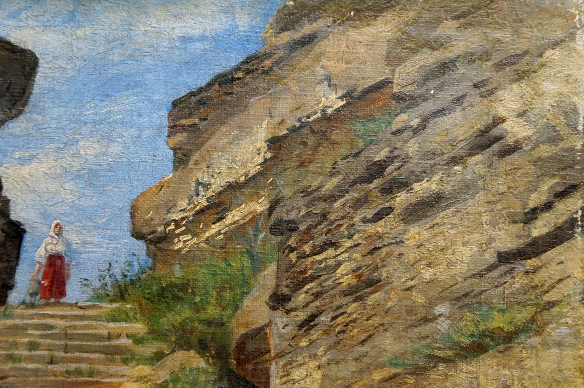 Oil painting of woman in white blouse and red skirt on stone steps by ancient cliff buildings