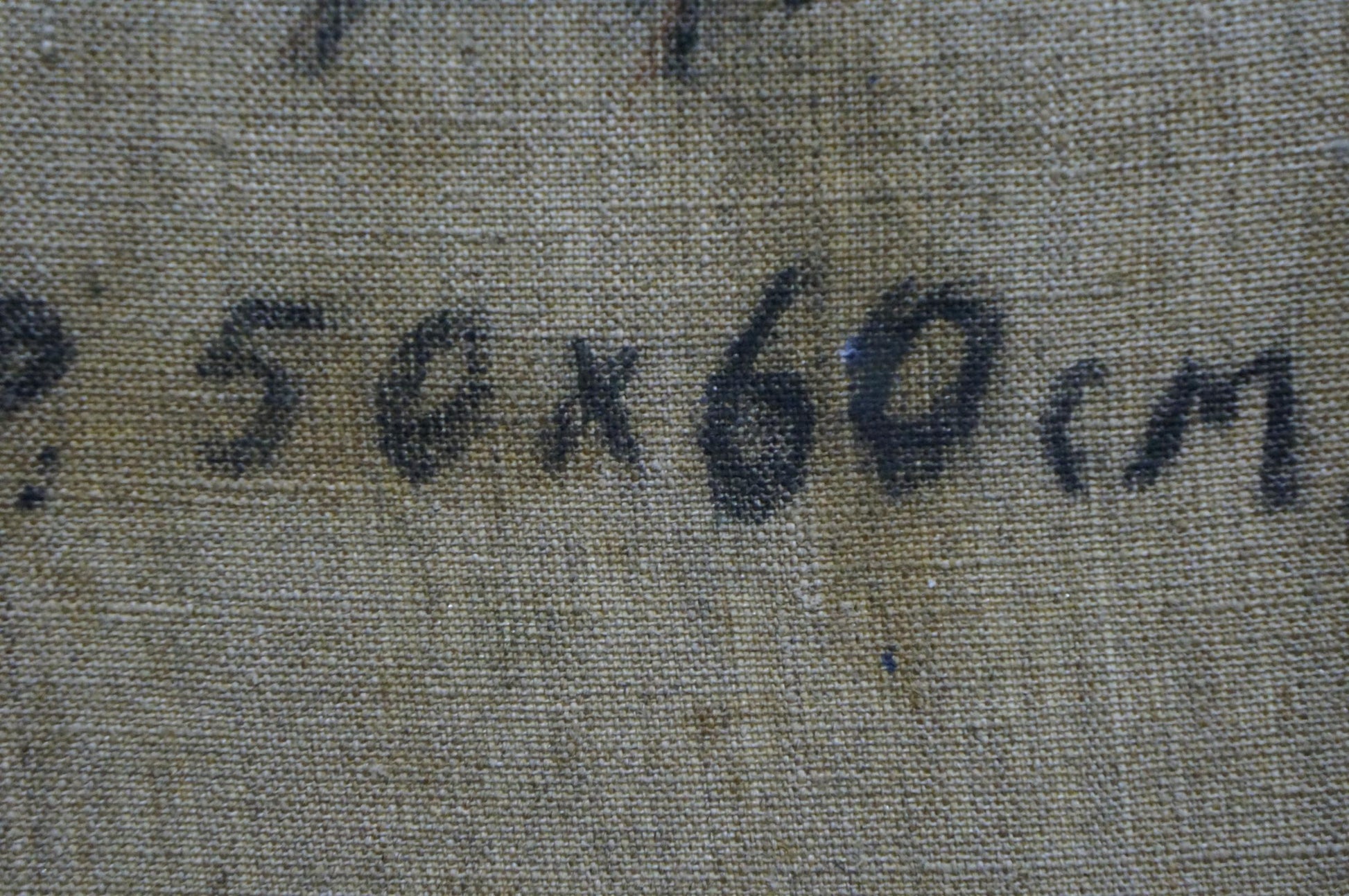 Back of Alexander Mynka oil painting with faded handwritten text on fabric