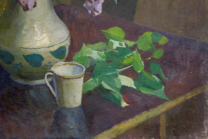 Oil painting of cream ceramic pitcher and cup with blue leaves, lilac and book