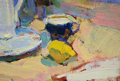 Oil painting of multicolored roses, lemon tea in dark blue cup with purple rim on yellow surface by Leonid Zaborovsky