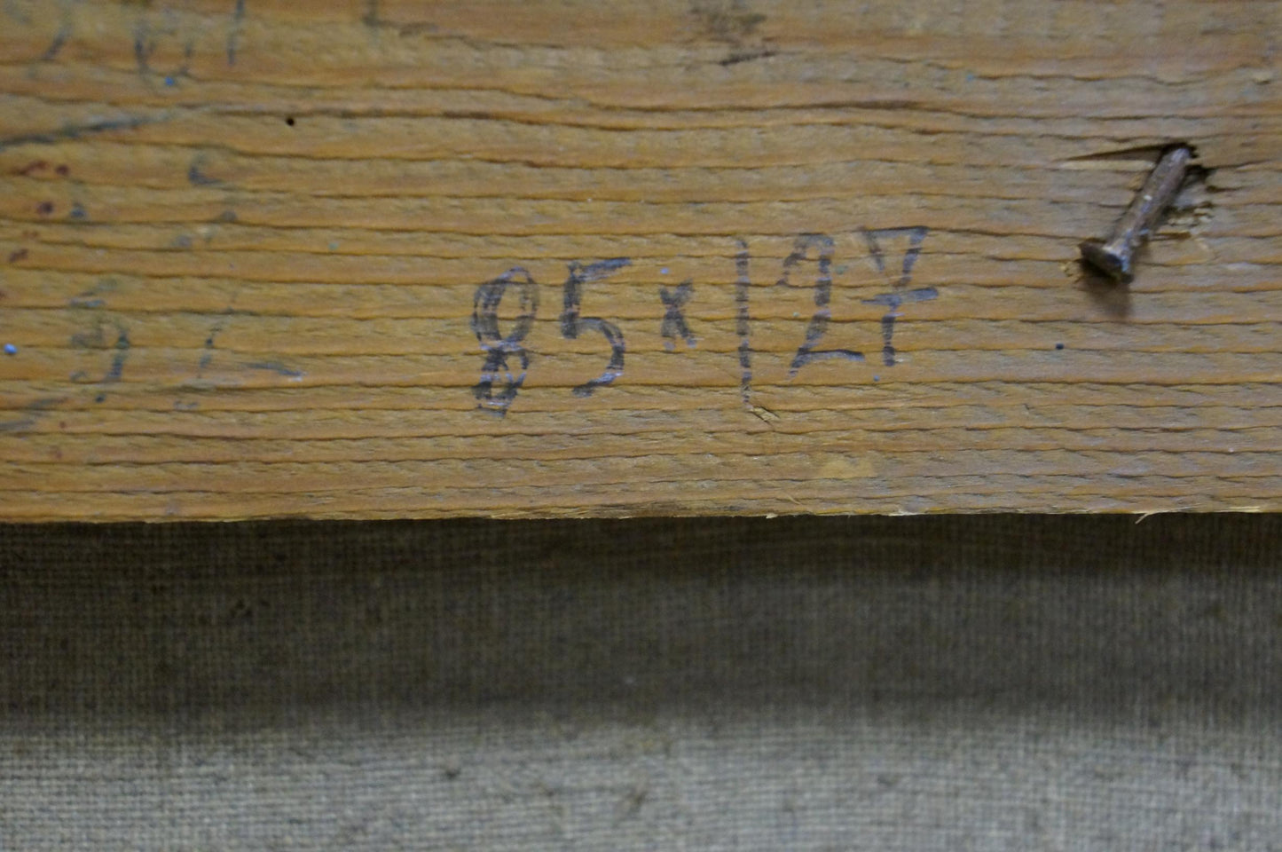 Back of Sevets Victor Stepanovich oil painting: worn plank with faded markings, rusted nail