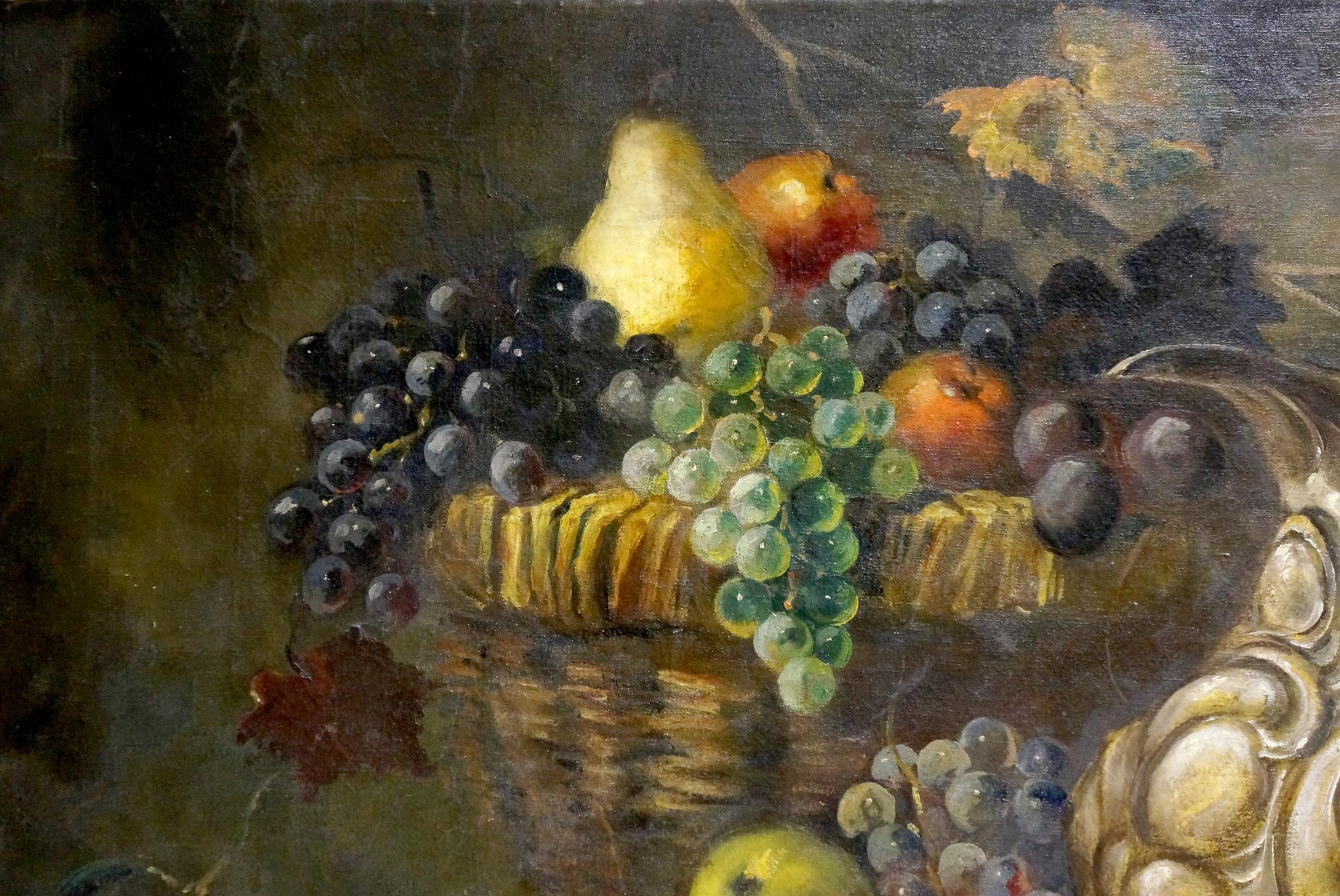 Oil painting still life with woven basket of grapes, pear, and oranges
