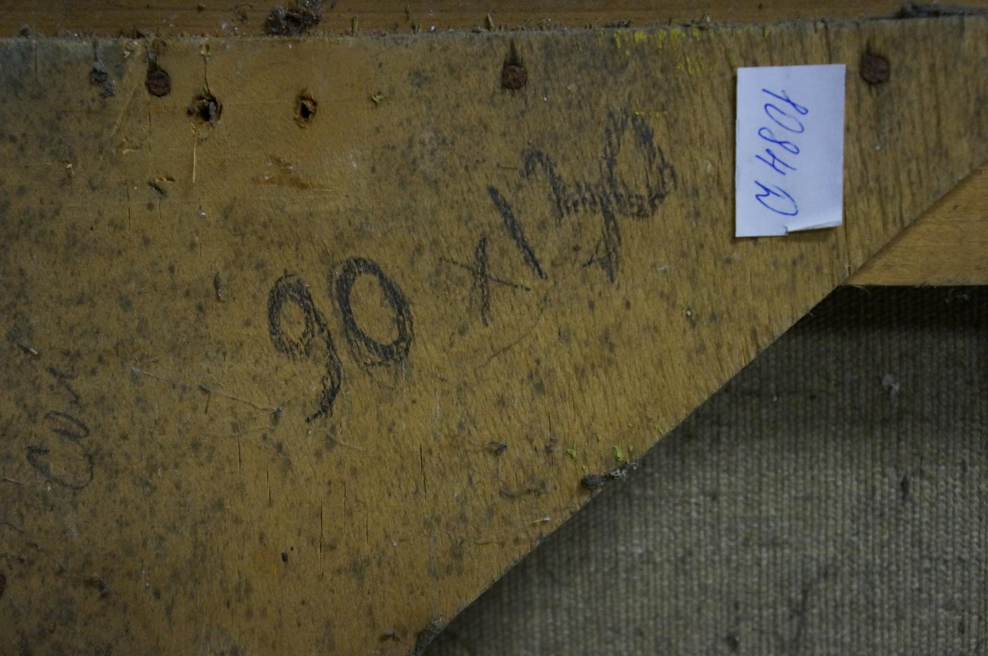 Back of Alexander Kerzhner oil painting: yellow wooden panel with dark markings and white label