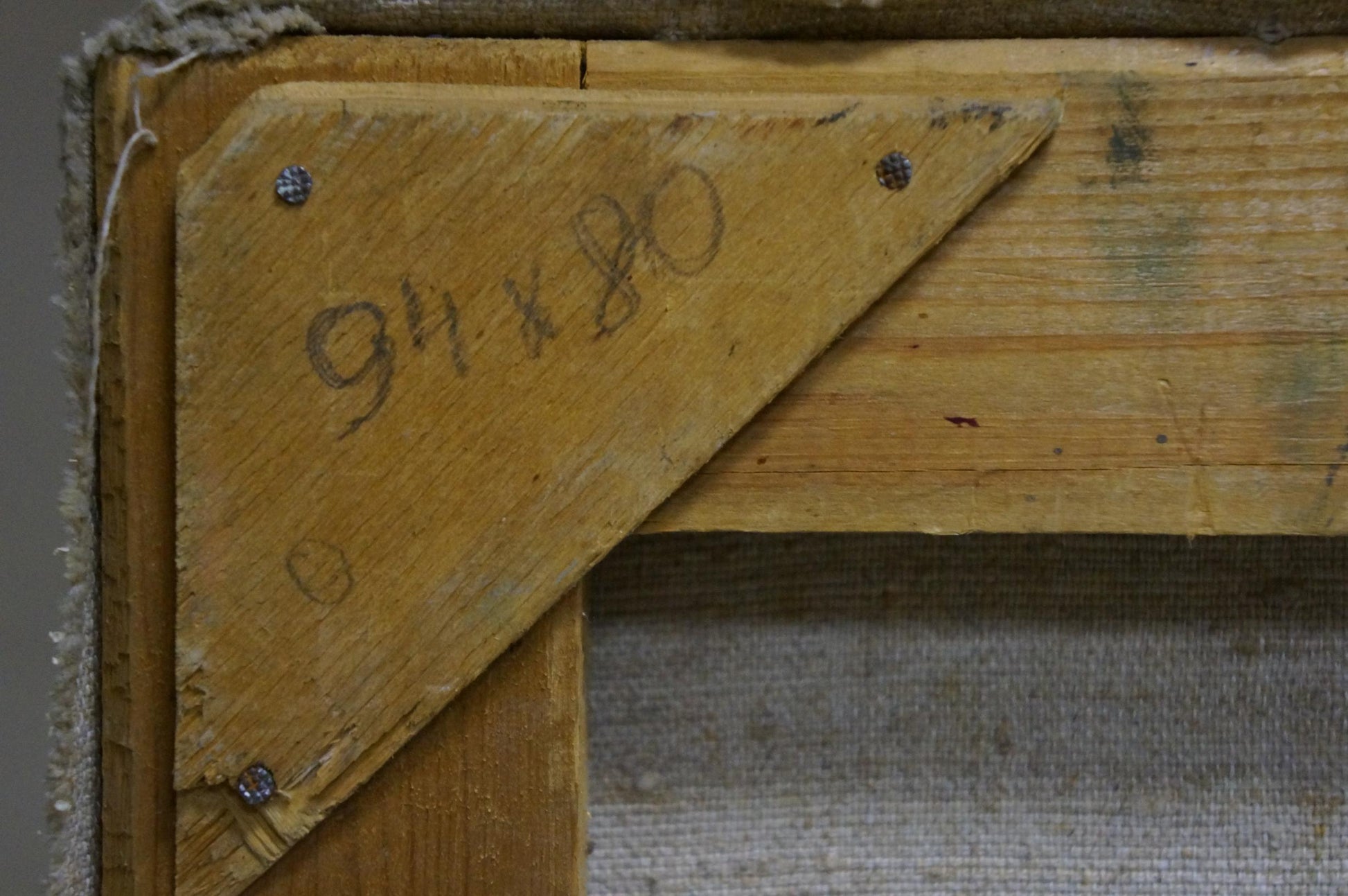 Back of oil painting by Kompaniyets-Kiyanchenko with worn yellow wooden corner bracket and hand-scribed dimensions
