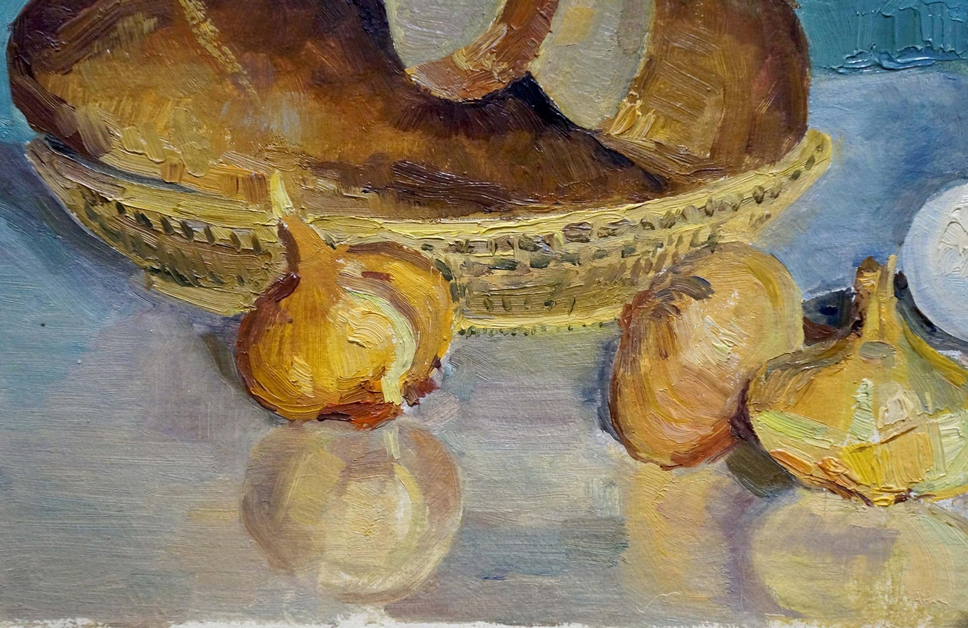 Oil painting of golden-brown bread loaf in woven wicker basket on table